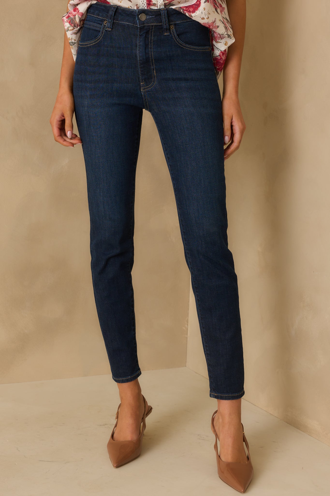 Dark wash skinny jeans with a high rise waist and sleek fitted leg design.
