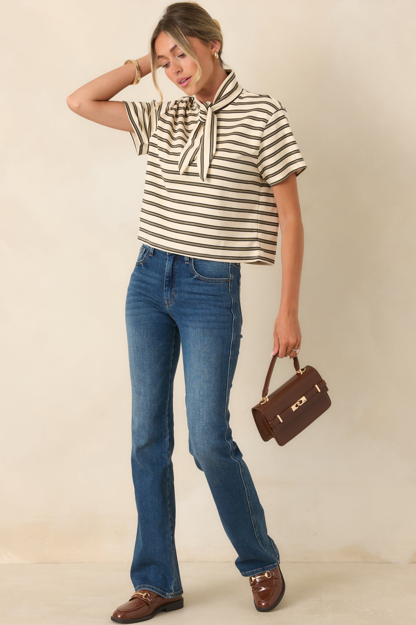 Dark wash bootcut jeans with a comfortable stretch fit, defined whiskering, belt loops, and a balanced flare below the knee.