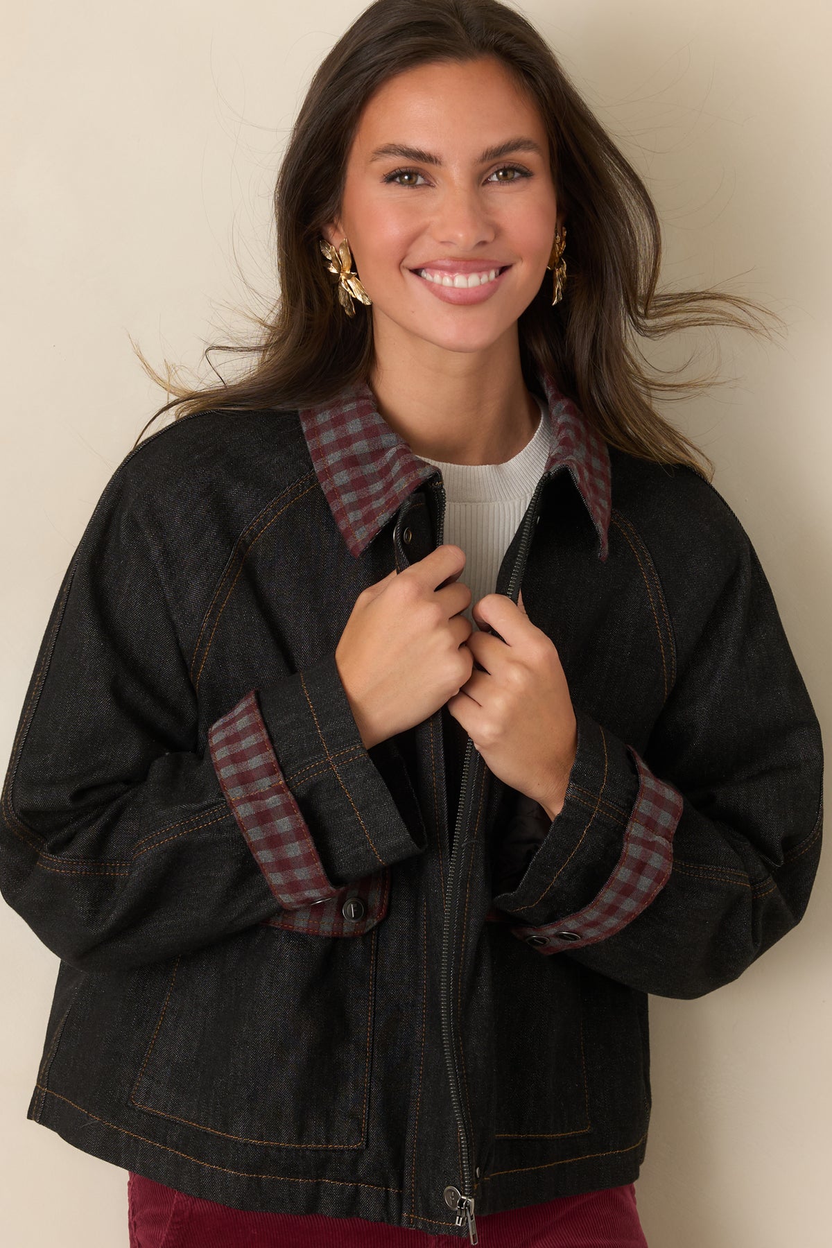Deep blue denim jacket featuring a relaxed fit, raglan sleeves, and contrasting gingham cuff details.