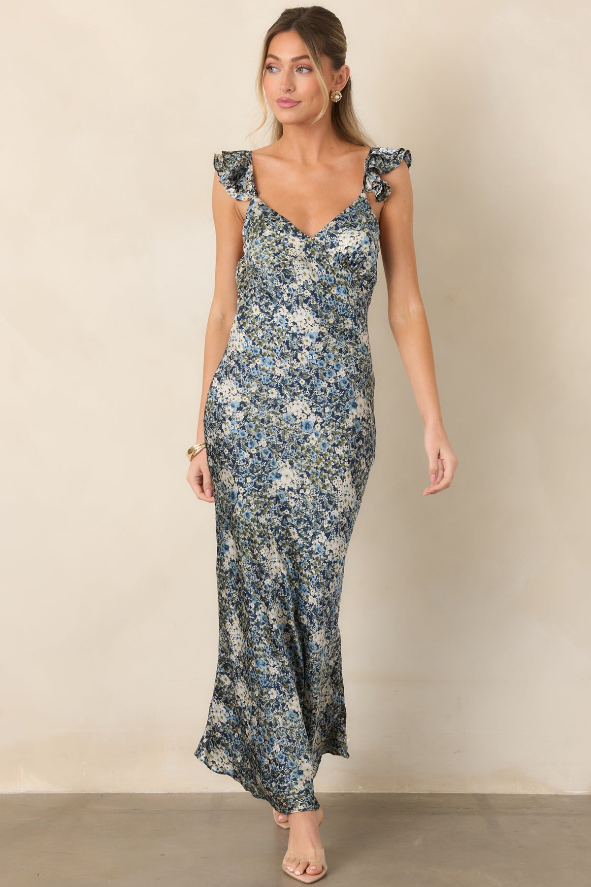 Deep blue floral satin dress with a fitted silhouette, V-neckline, and ruffled shoulder straps.
