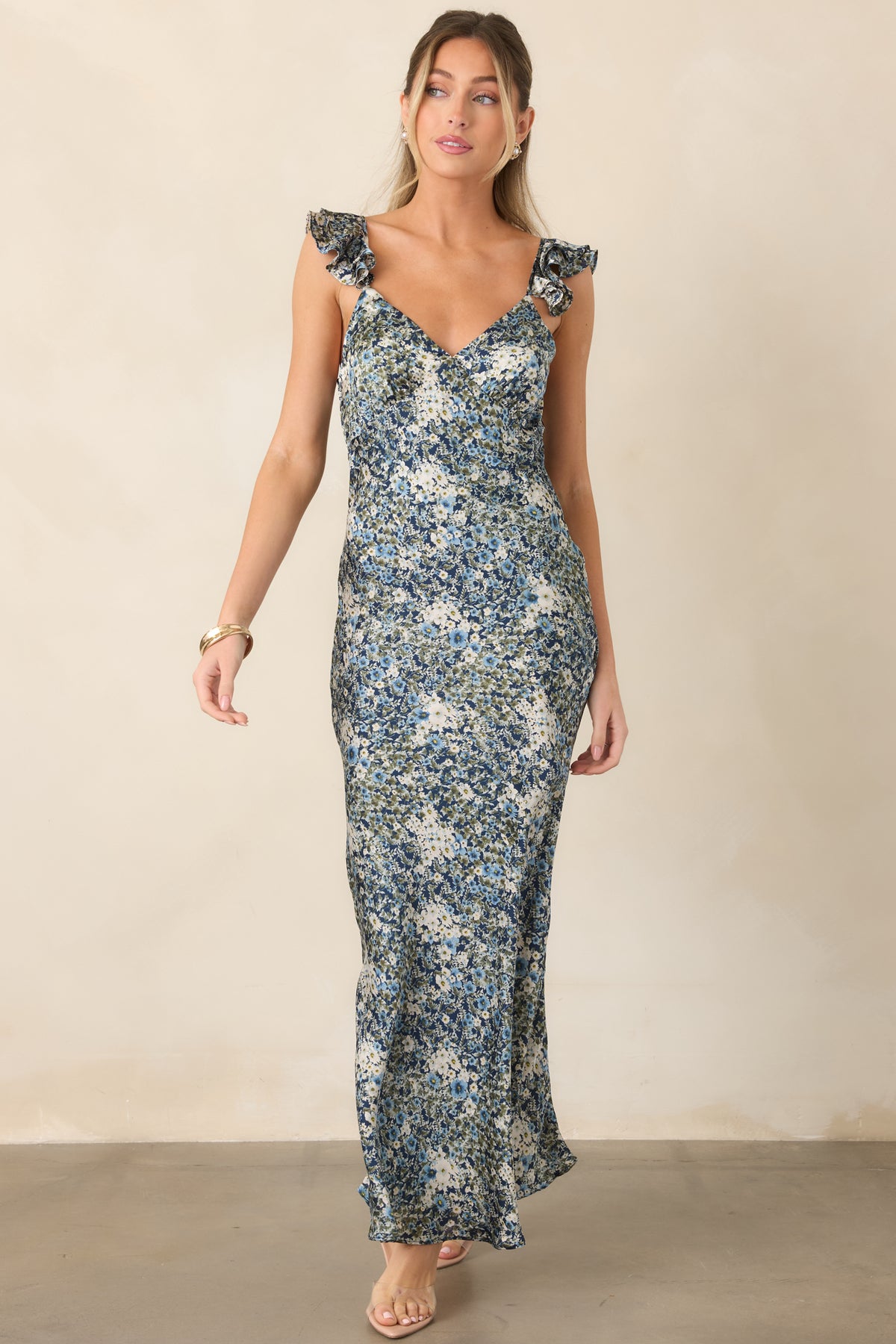 Deep blue satin floral dress with a sleek silhouette and delicate shoulder strap detailing.

