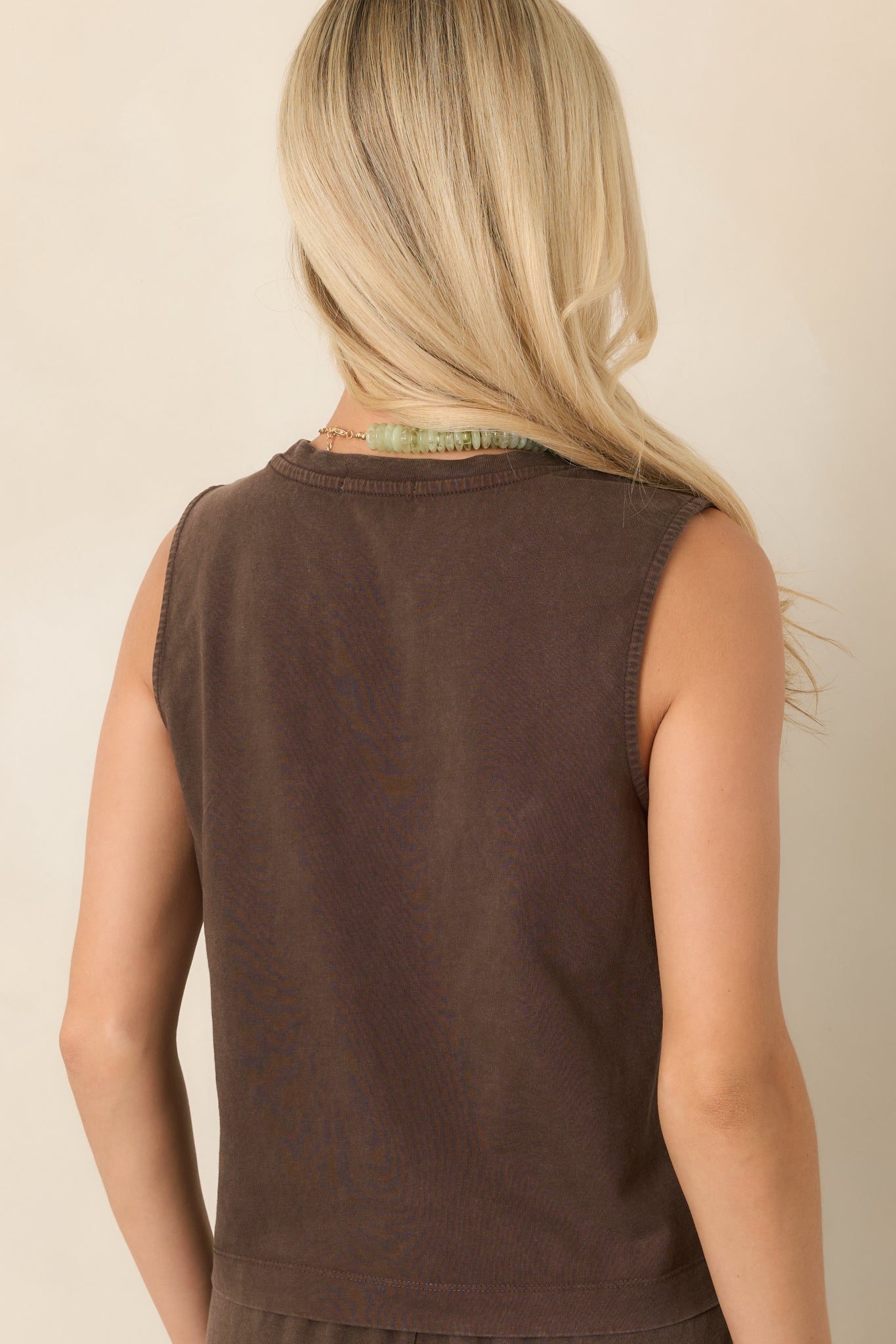 Rear view of the deep brown cotton jersey tank showing the sleeveless muscle tank cut and relaxed silhouette.