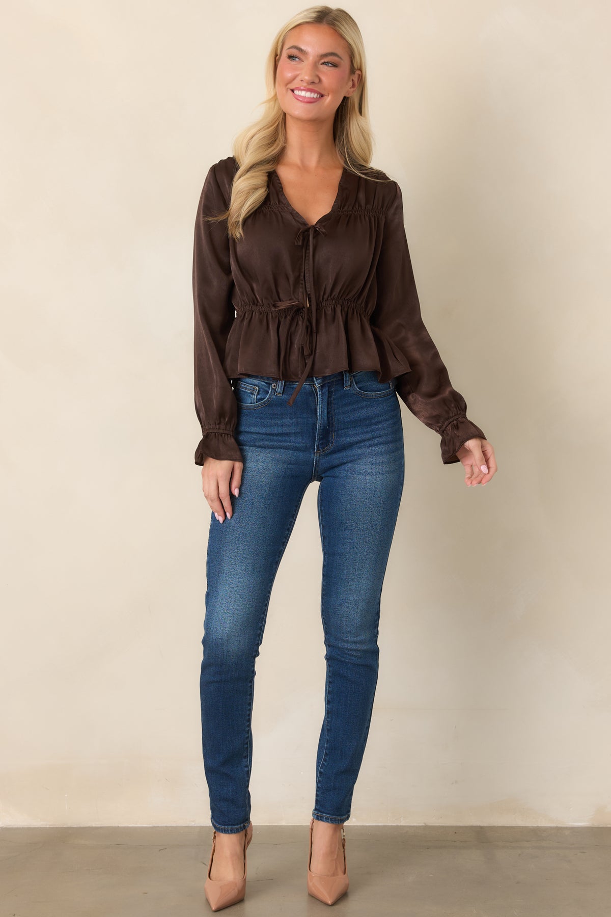 Deep brown blouse showcasing voluminous poet sleeves, elastic cuffs, an adjustable drawstring waist, and a softly draped peplum hem.