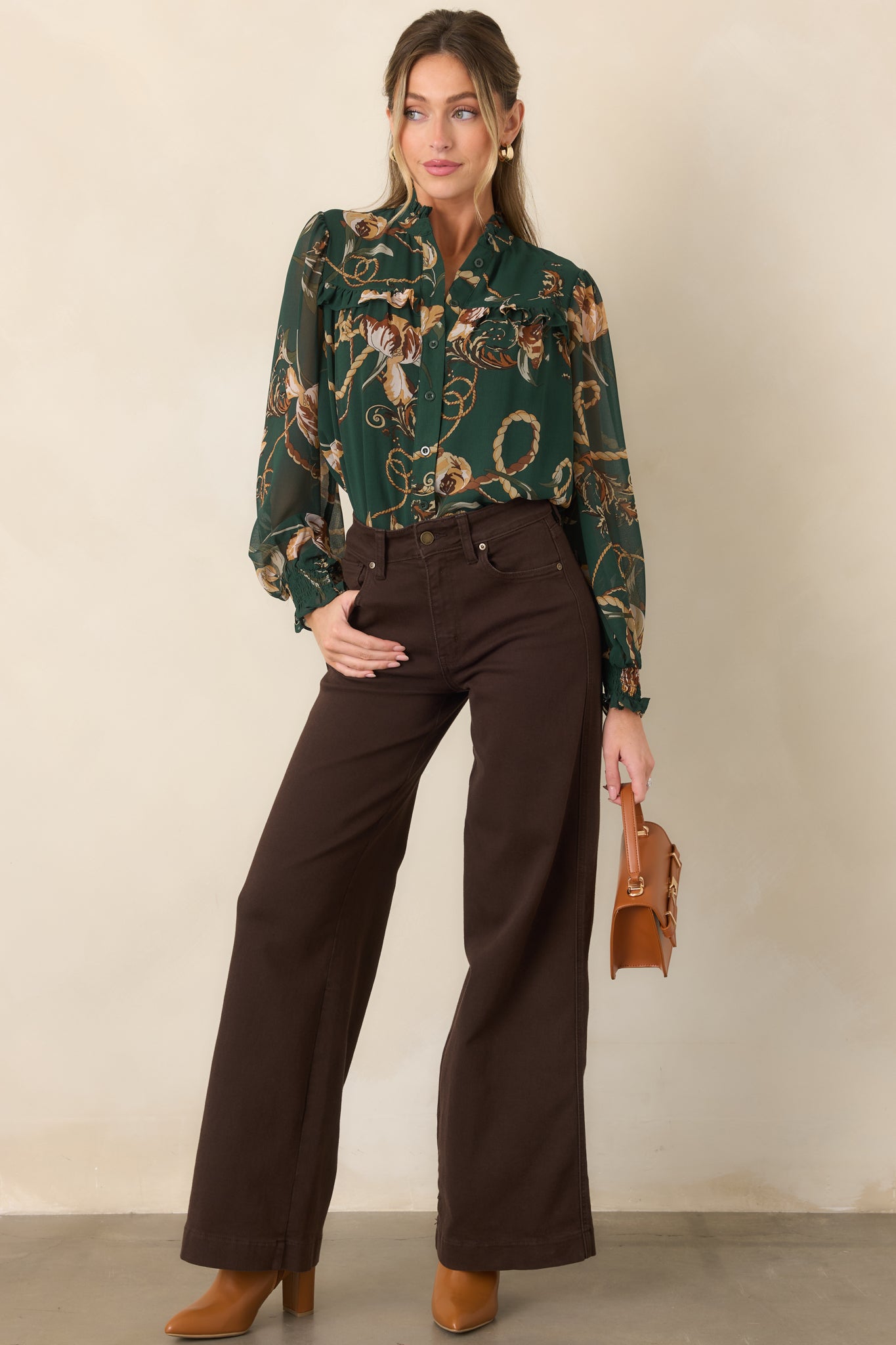 Deep forest green blouse featuring airy sheer sleeves, elasticized smocked cuffs, a ruffled collar, and feminine layered detailing.