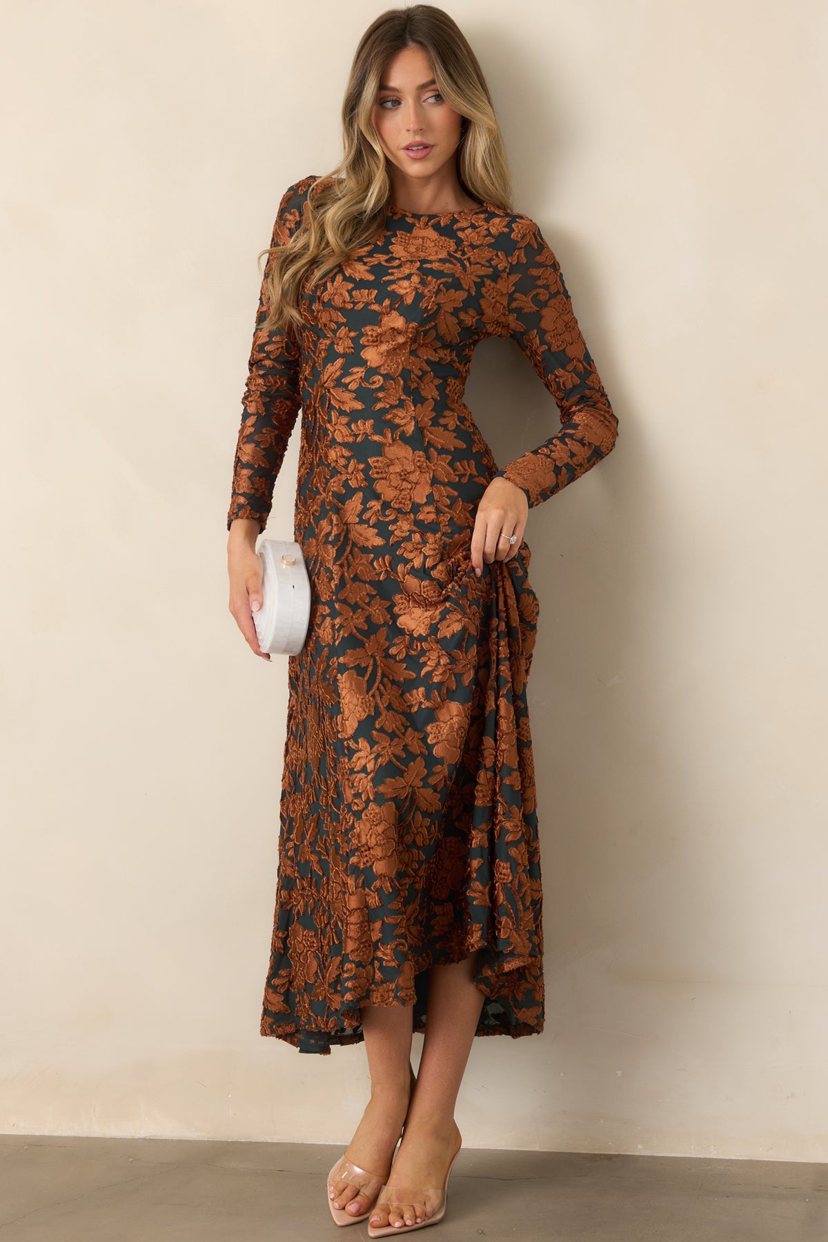 Deep green floral midi dress with a fitted upper silhouette, raised copper embellishments, and a sweeping skirt.