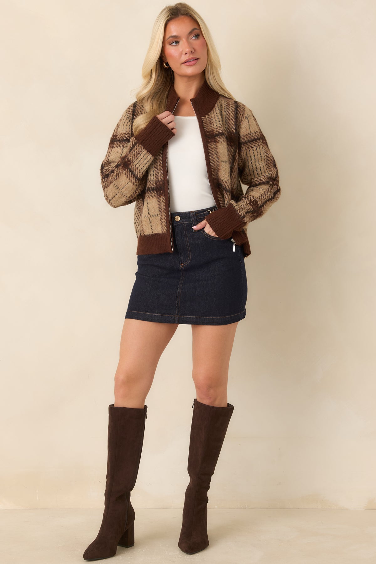 Deep indigo denim mini skirt with warm contrast stitching, gold-tone hardware, and a gently flared hem.