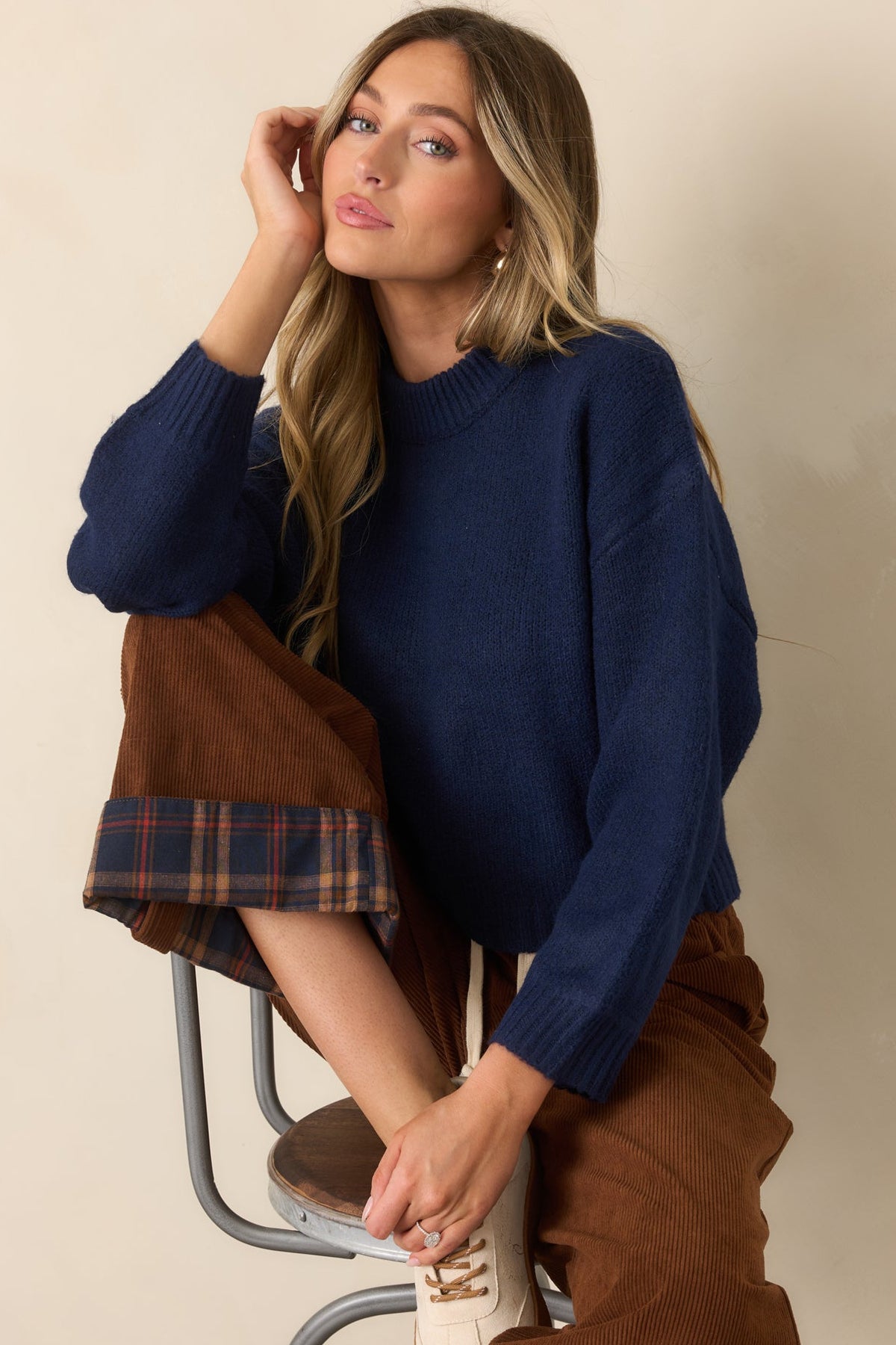 Deep navy knit pullover highlighting the ribbed hem and relaxed boxy silhouette.
