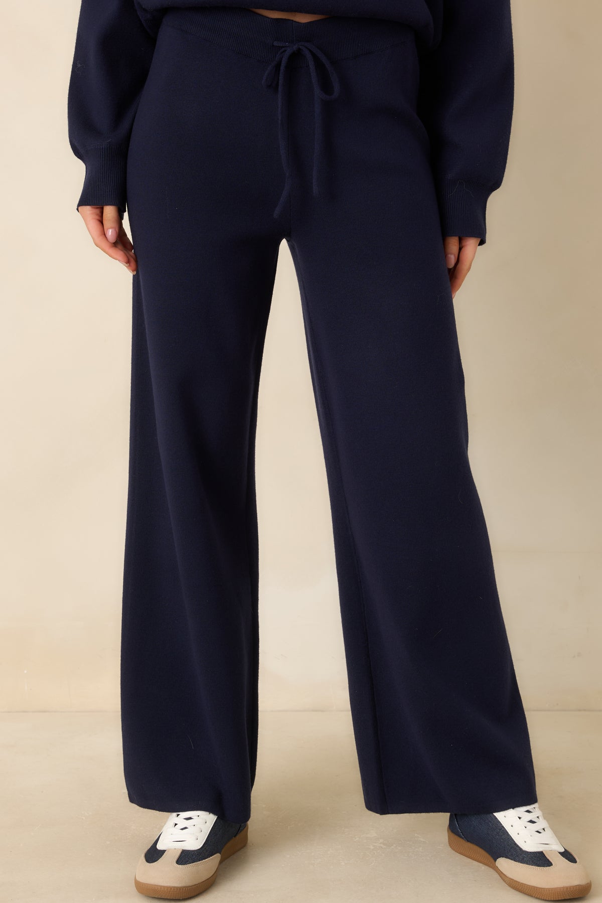 Side seam pocket detail on the deep navy sweater-knit pants.