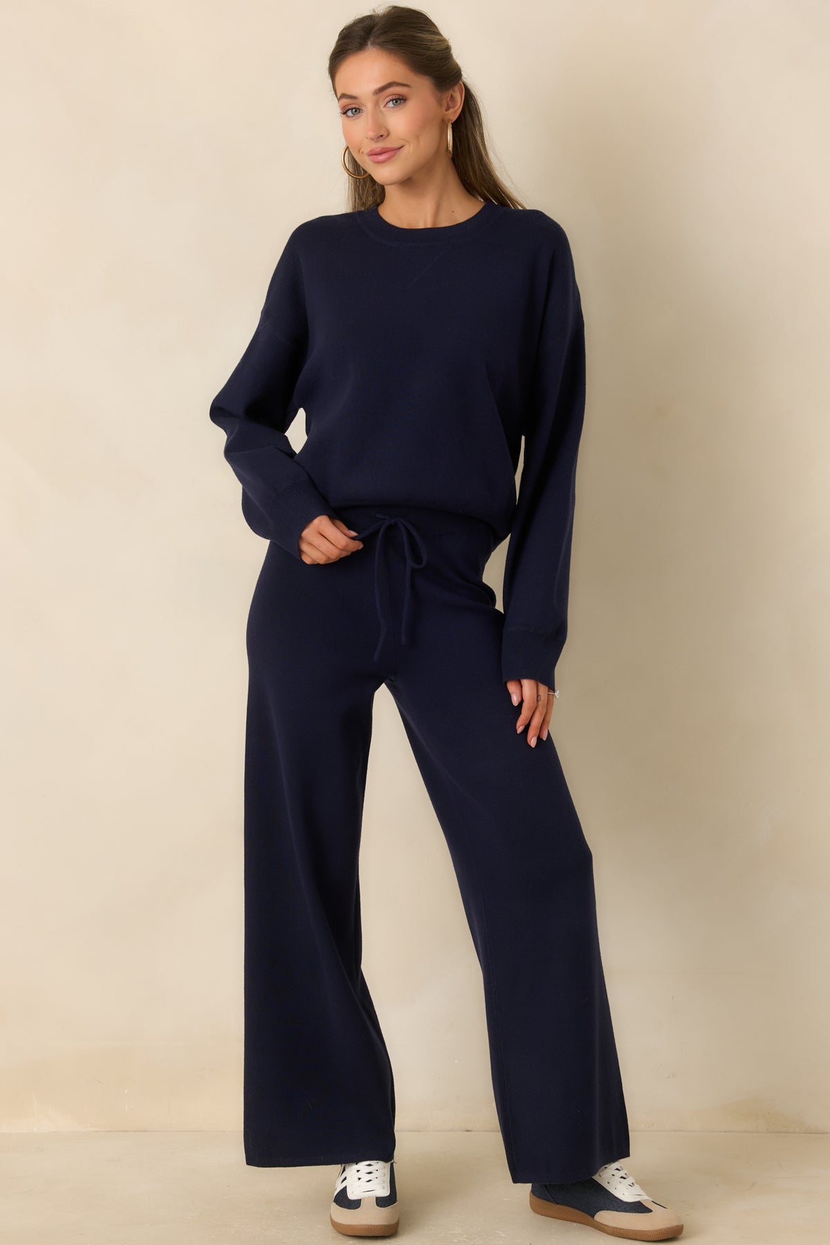 Deep navy sweater-knit pants with a high-rise elastic waistband, adjustable drawcord, and relaxed wide legs.