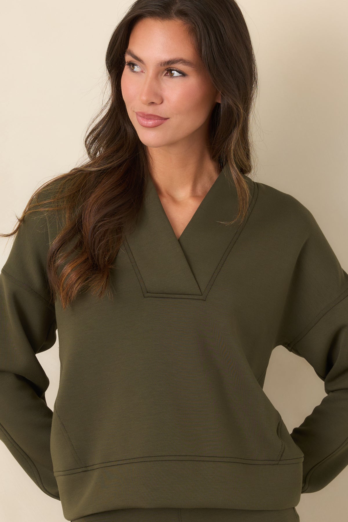 Deep olive-green top showcasing the smooth AirEssentials® fabric and relaxed dropped-shoulder construction.