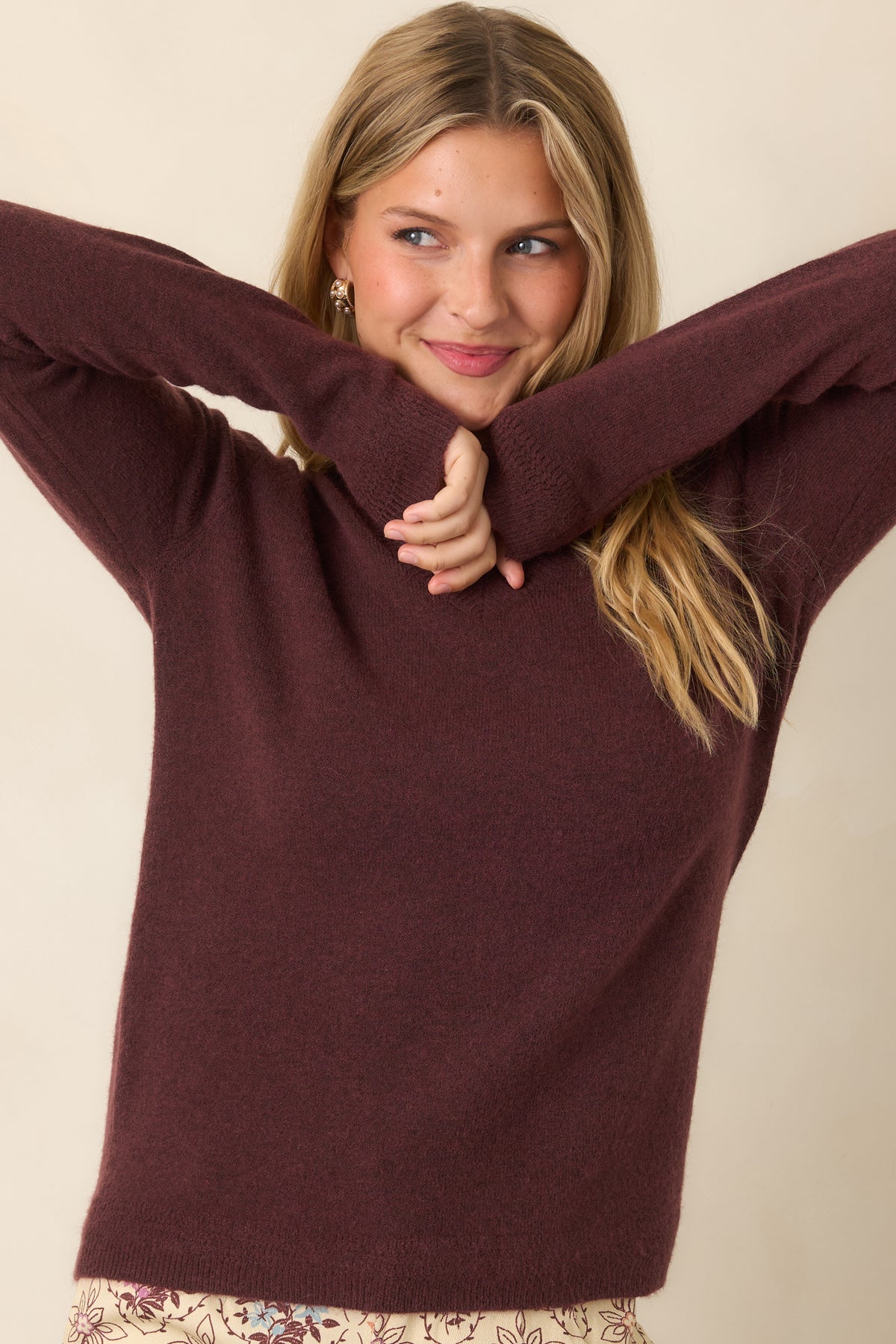 Deep raisin knit top featuring long sleeves and ribbed cuffs for a polished finish.