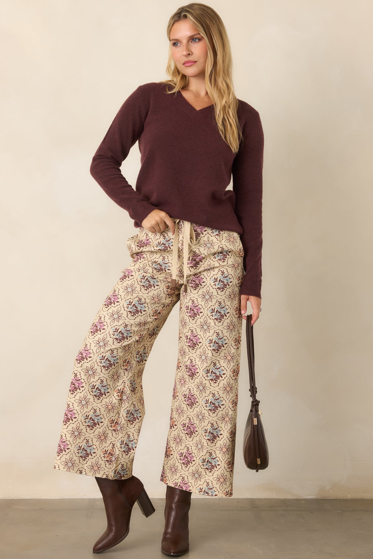 Deep raisin knit top featuring a classic V-neckline and long sleeves.