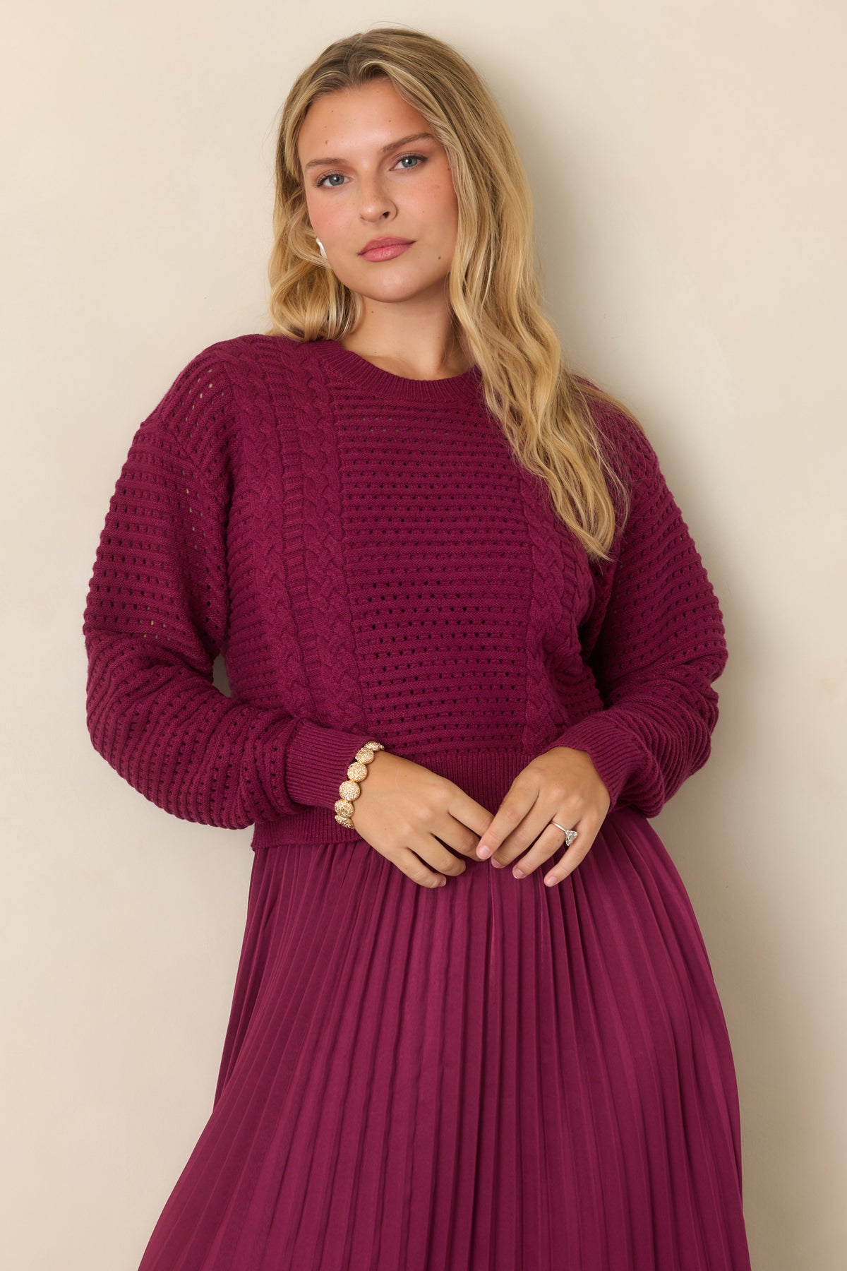 Deep raisin top displaying the V-neckline and softly textured knit construction.
