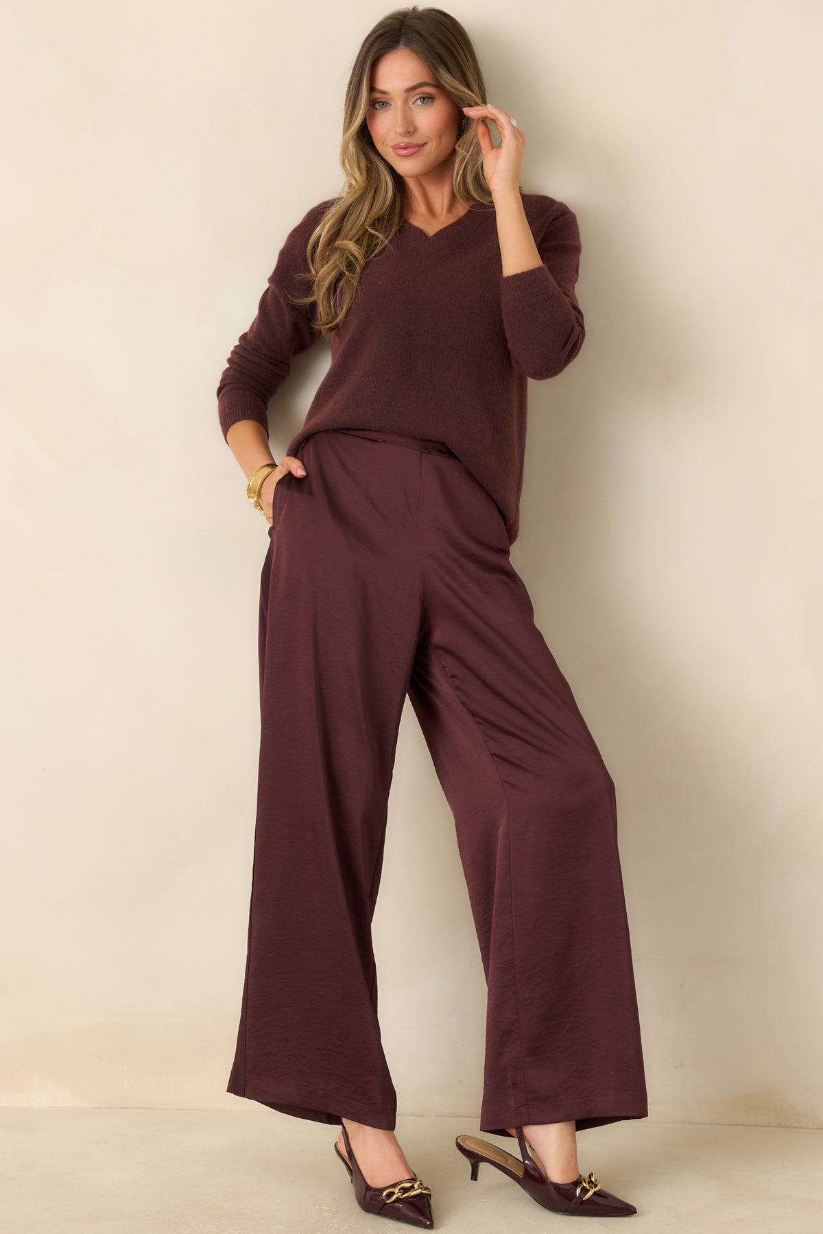 Deep raisin V-neck sweater with long sleeves, a relaxed silhouette, and ribbed trim at the neckline, cuffs, and hem.