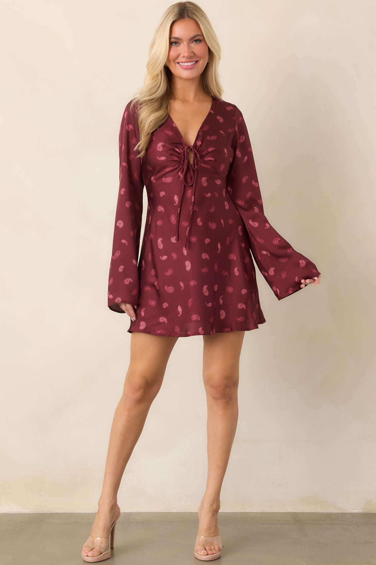 Deep wine satin mini dress featuring a fluid bias-cut silhouette and tonal paisley print.