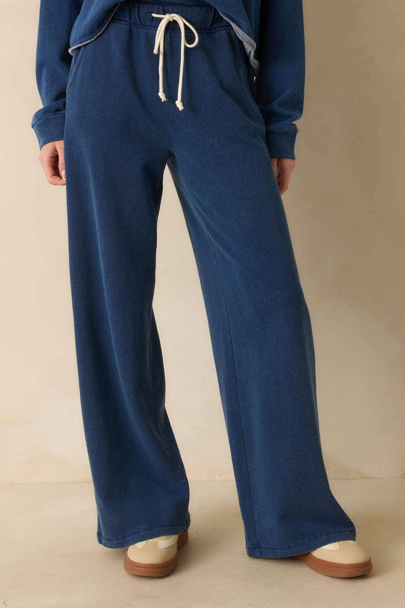 Close view of the waistband with adjustable drawstring and smooth knit texture.