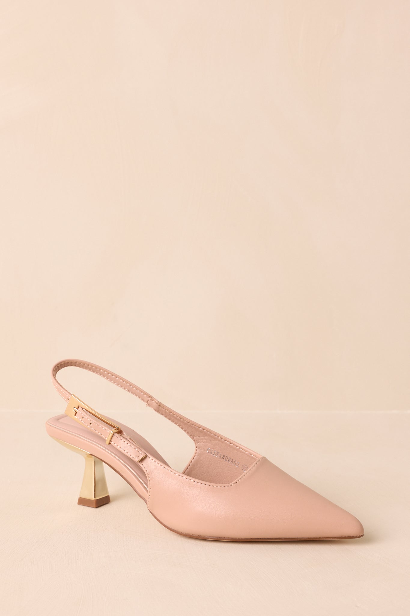 Detail of cushioned insole and gold metallic kitten heel.