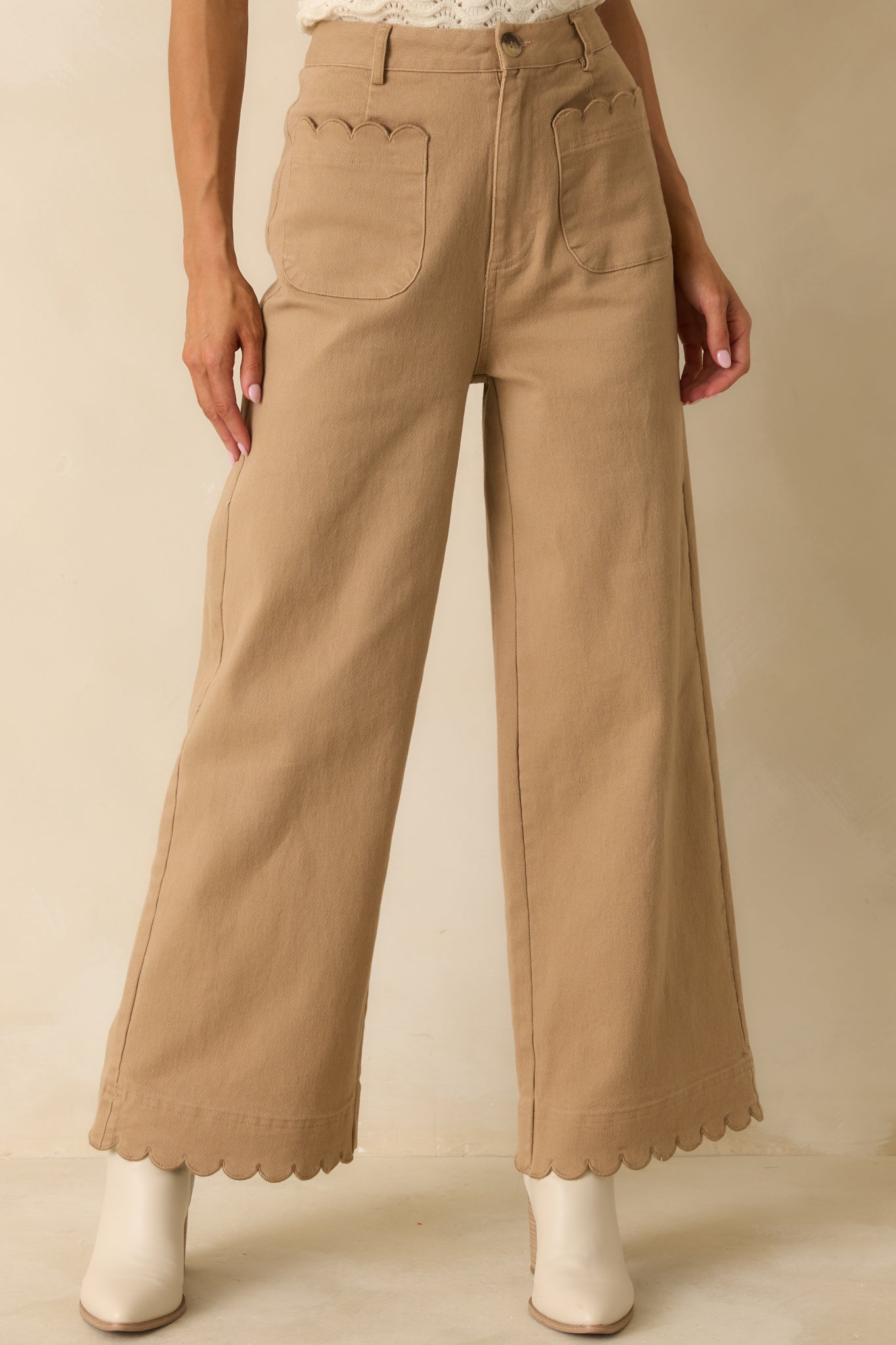 Detail emphasizing the scalloped hemline and structured cotton texture.