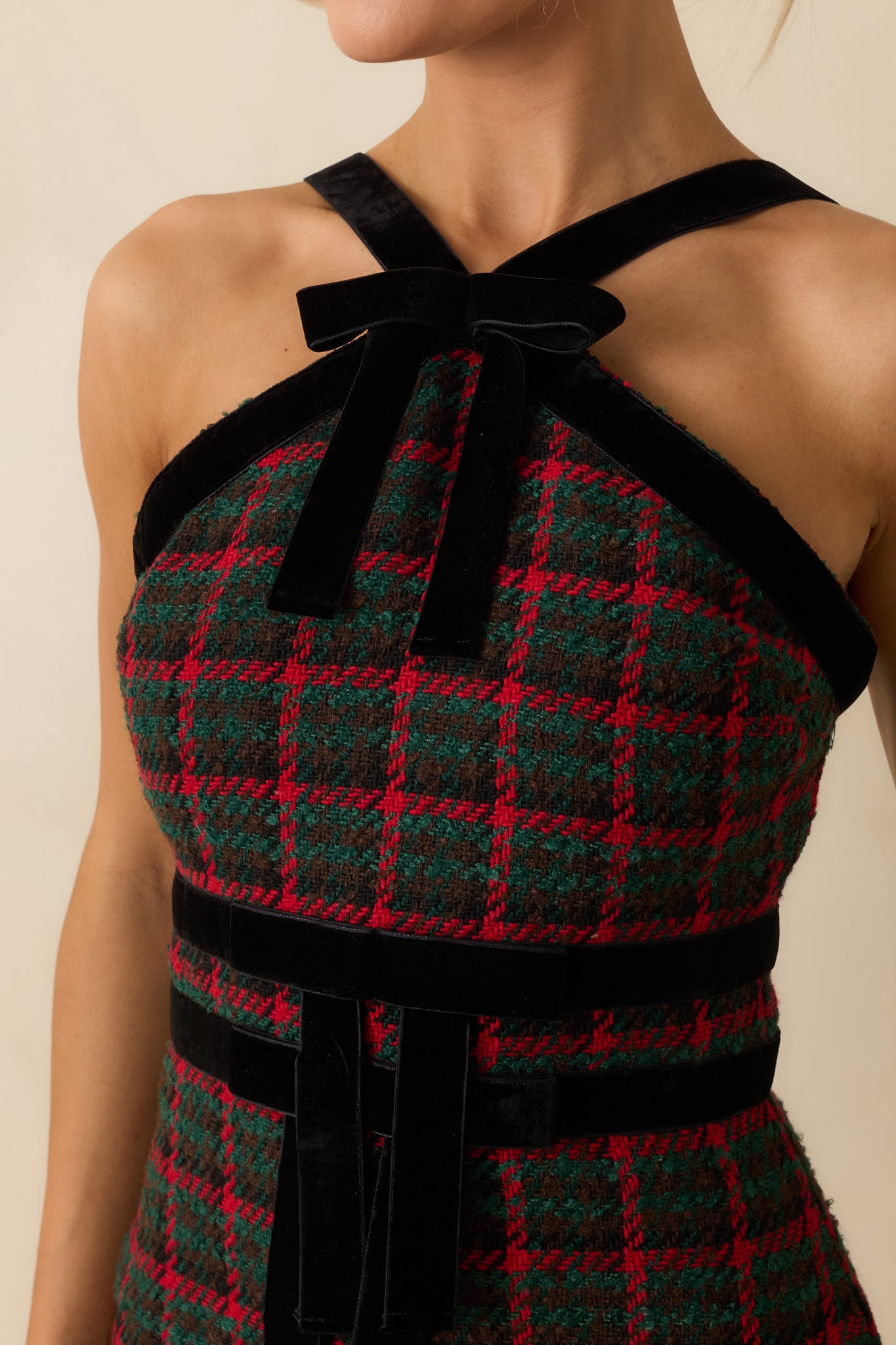 Detailed view highlighting the velvet bow, soft trim, and the rich texture of the plaid tweed fabric.