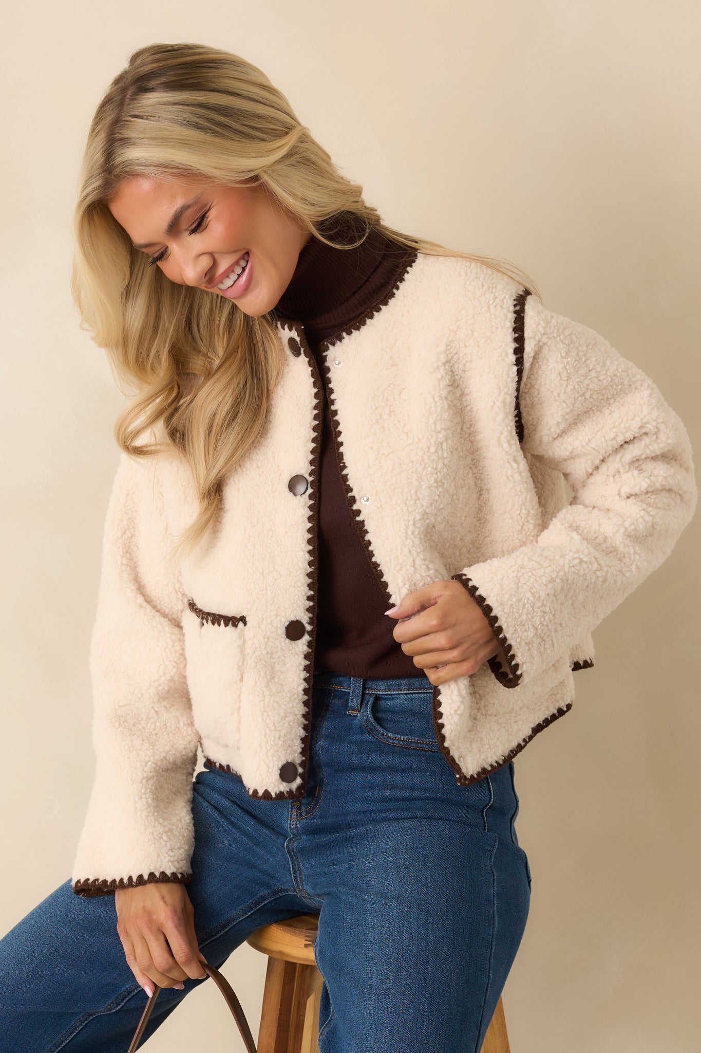 Detail look at the snap-button front framed by the soft, plush sherpa surface.