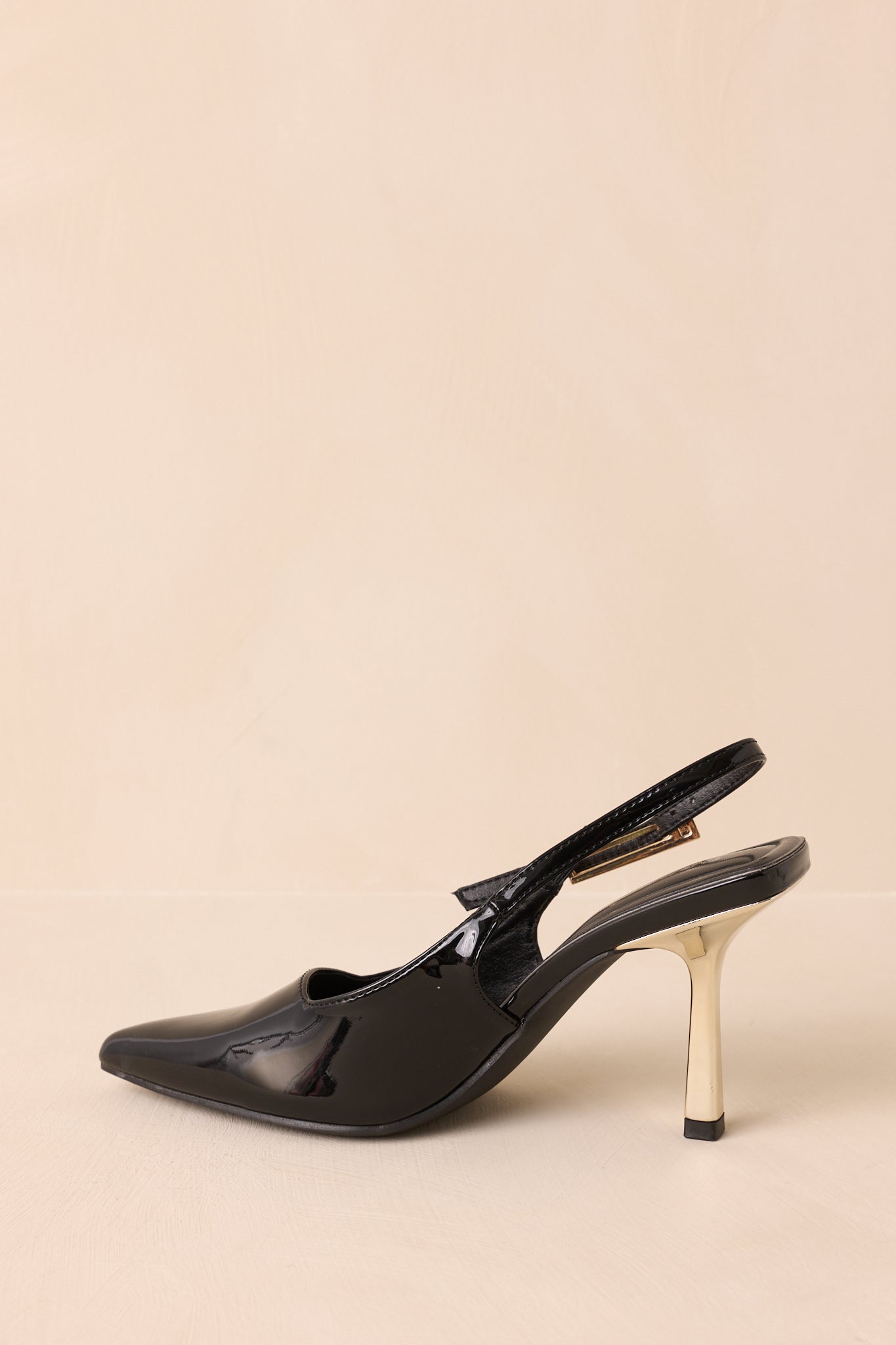  Detail of pointed toe and glossy patent finish on the heels.