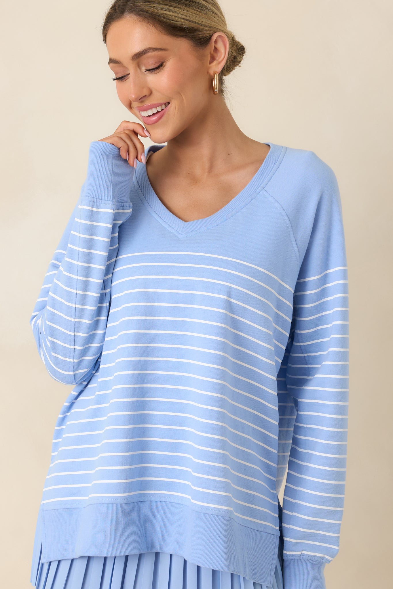 Detail view of the horizontal stripes and soft, lightweight fabric texture of the light blue weekender