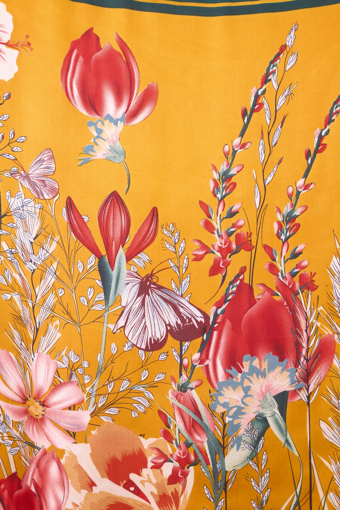 A zoomed-in detail shot of the scarf's pattern, showcasing flowers and a butterfly in bright hues.