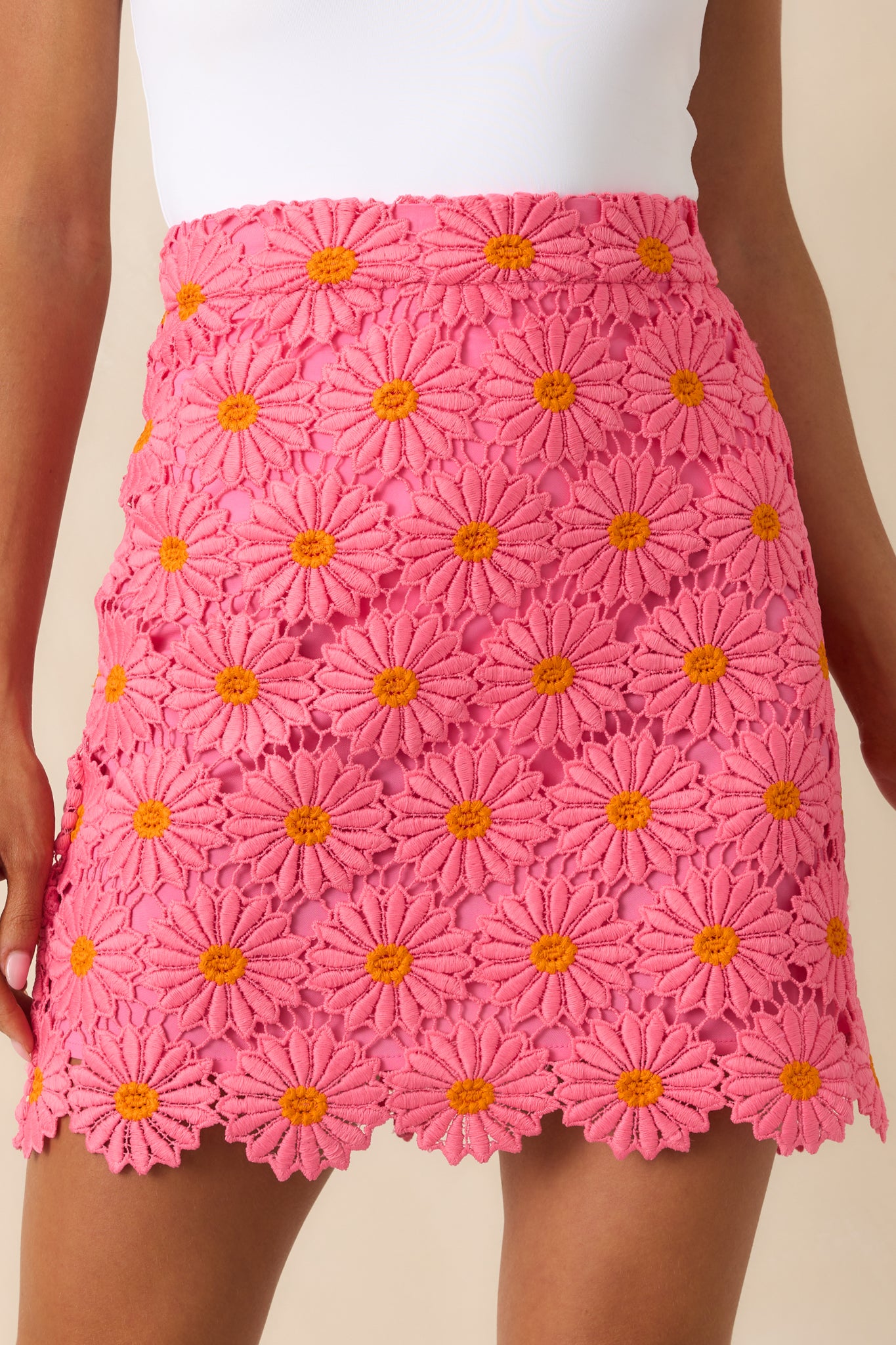 Detailed close-up of the embroidered floral lace overlay, showing the texture and color contrast of the hot pink, pink, and orange threadwork.