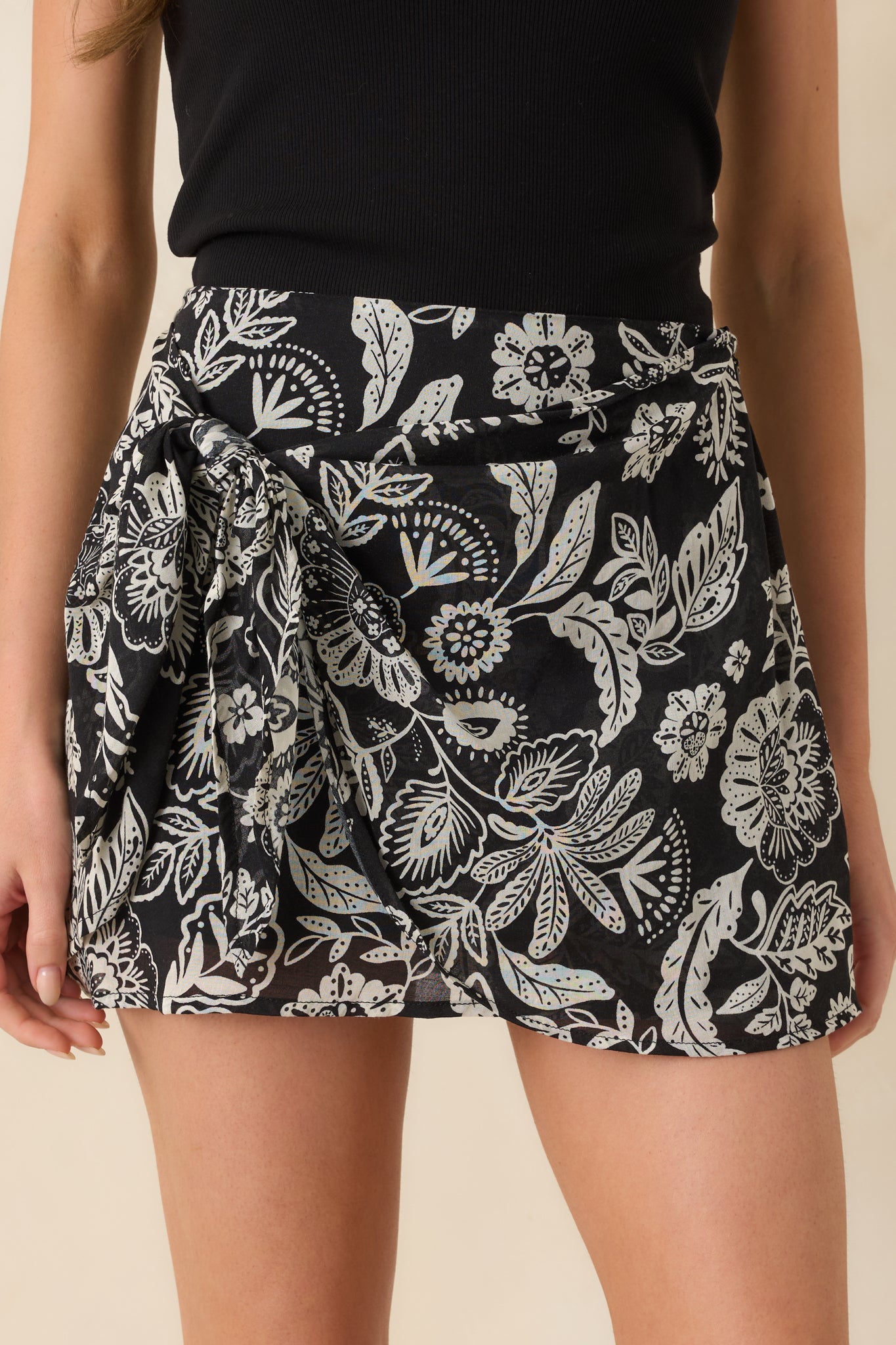 Detailed close-up of skirt highlighting intricate floral pattern and refined fabric texture.