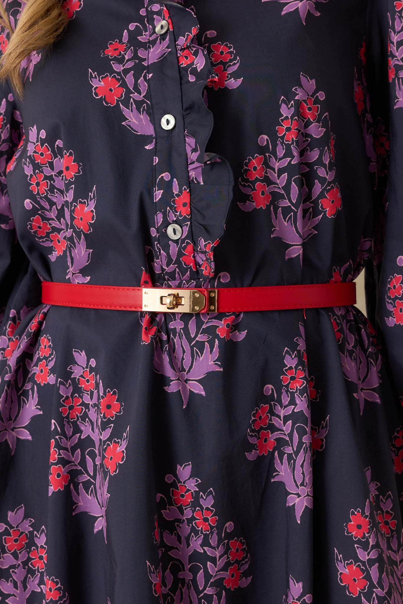 Detailed close-up capturing the gold twist-lock mechanism and smooth red material texture.