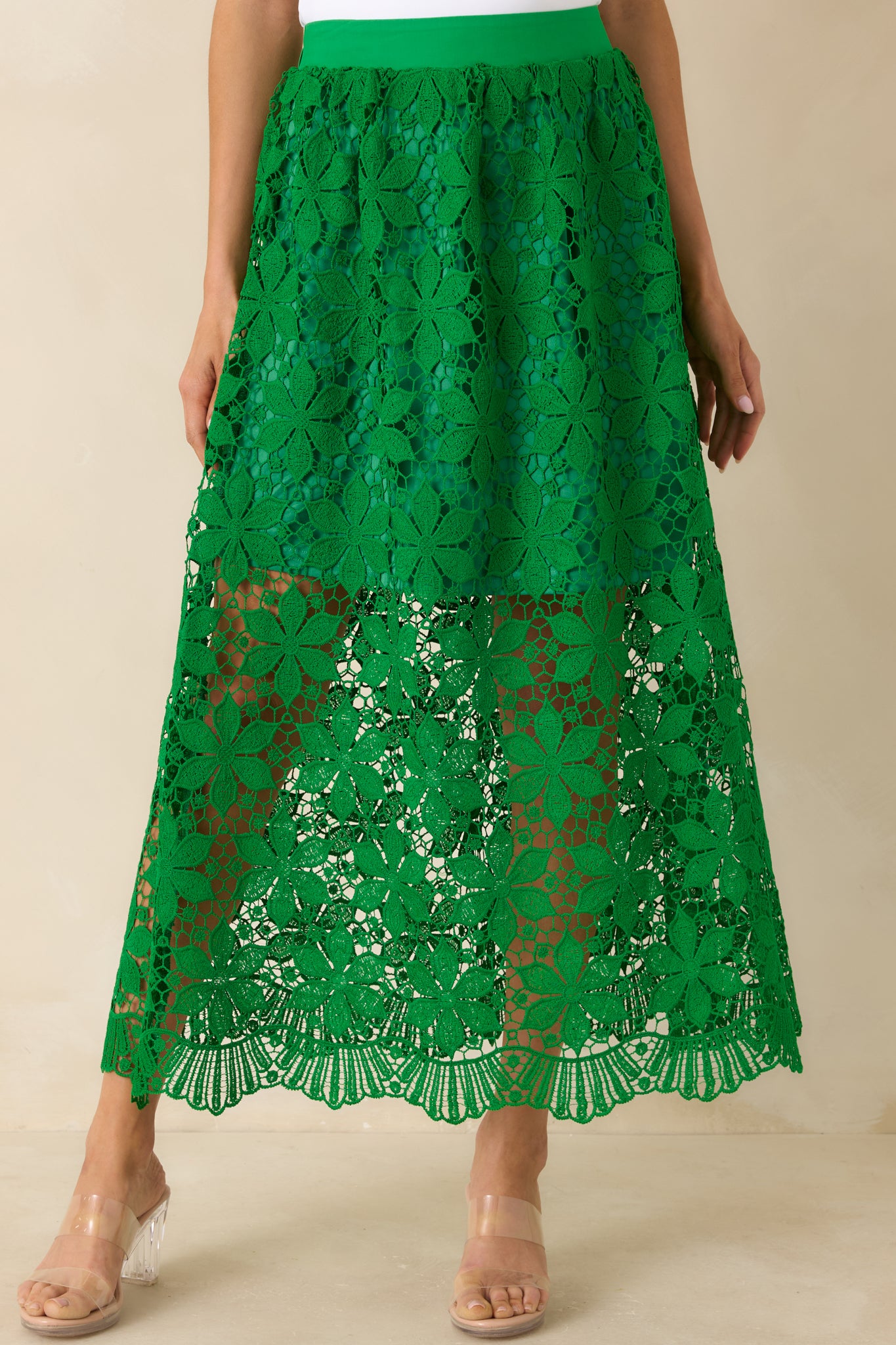 Detailed green crochet lace skirt with layered lining and soft movement.