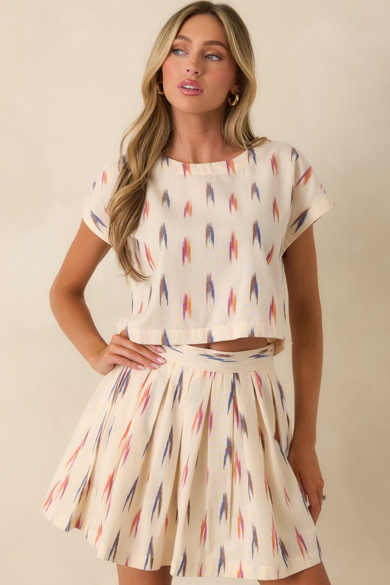 Detailed look at the round neckline and vibrant artistic pattern.
