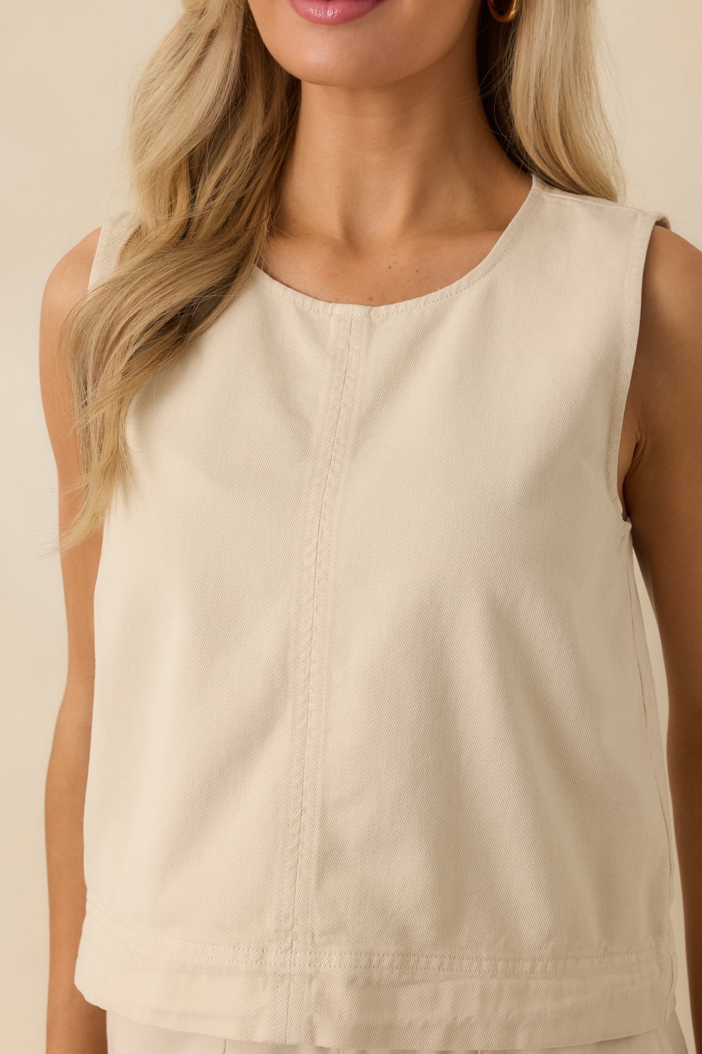 Detailed look at the lightweight woven fabric, wide shoulder straps, and clean cropped hem.