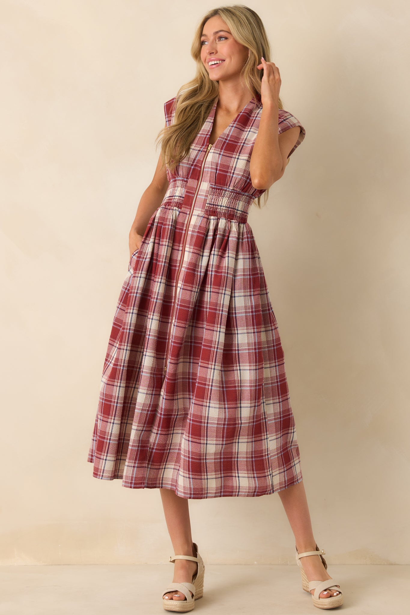 Detailed look at the v-neckline and fitted smocked waist enhancing the flowing skirt.