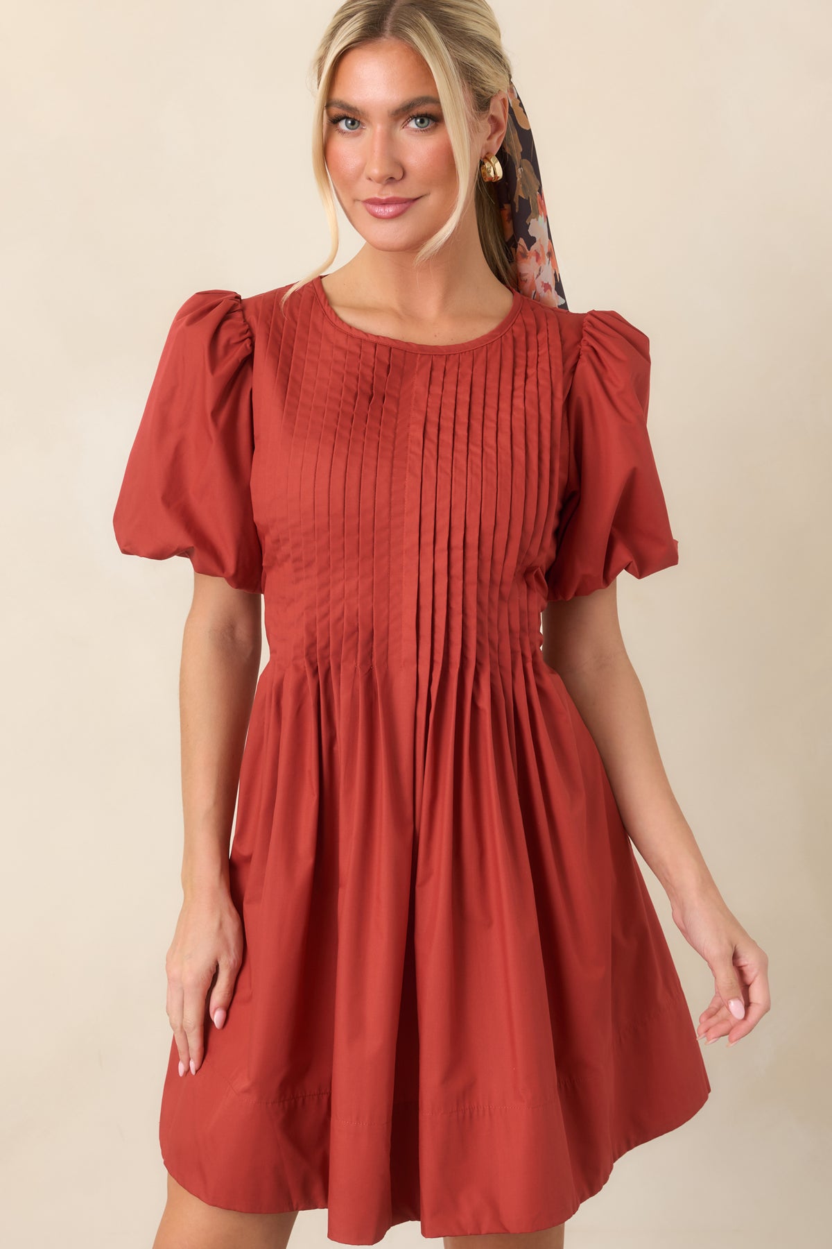 Detailed pintucking adds texture across the bodice of this mini dress, paired with a voluminous gathered skirt.