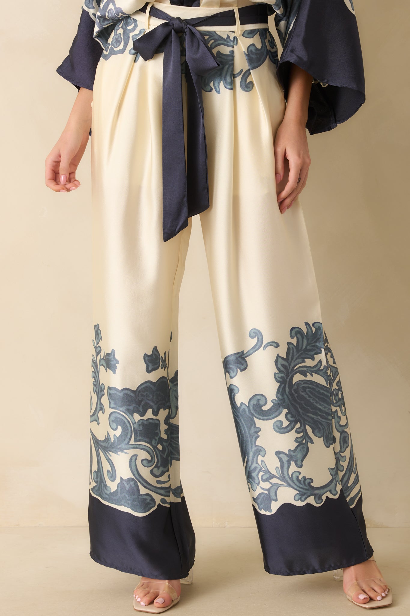 Detailed shot of the ivory fabric and navy ornate border print, showing texture and stitching.