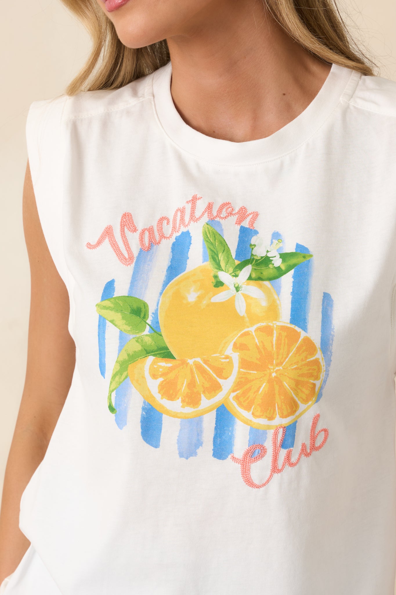 Detailed view of bold citrus-inspired graphic and lettering on breathable cotton fabric.