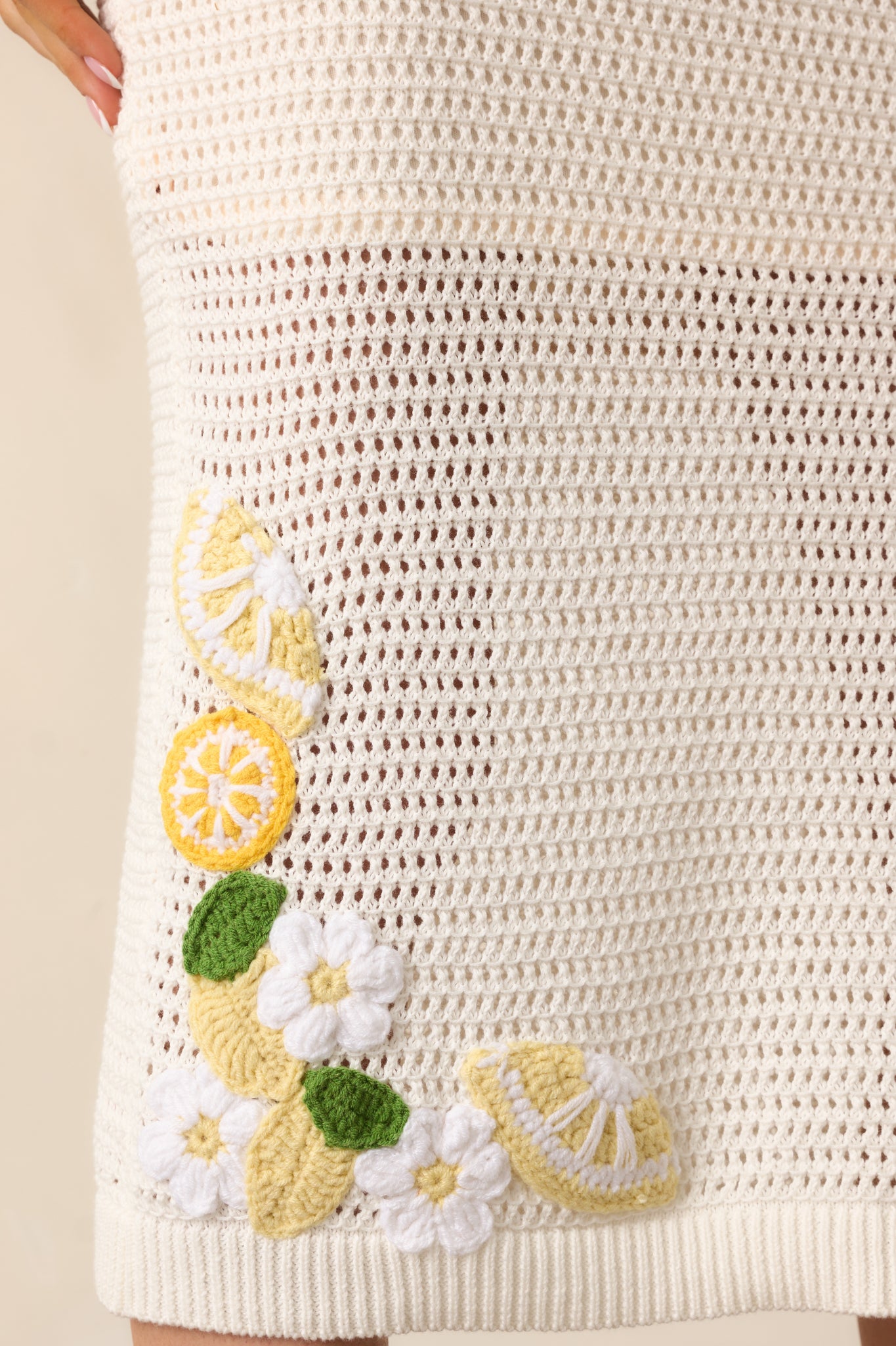 A detailed view of the 3D crochet lemon appliqués, adding a whimsical touch to the skirt’s intricate knit.