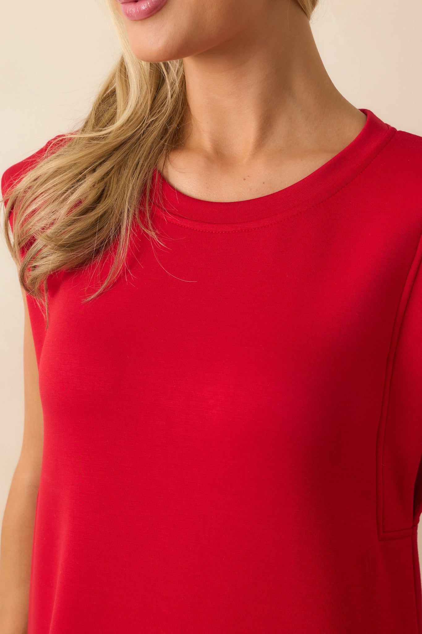 Detailed view of the crew neckline and cap sleeve stitching.