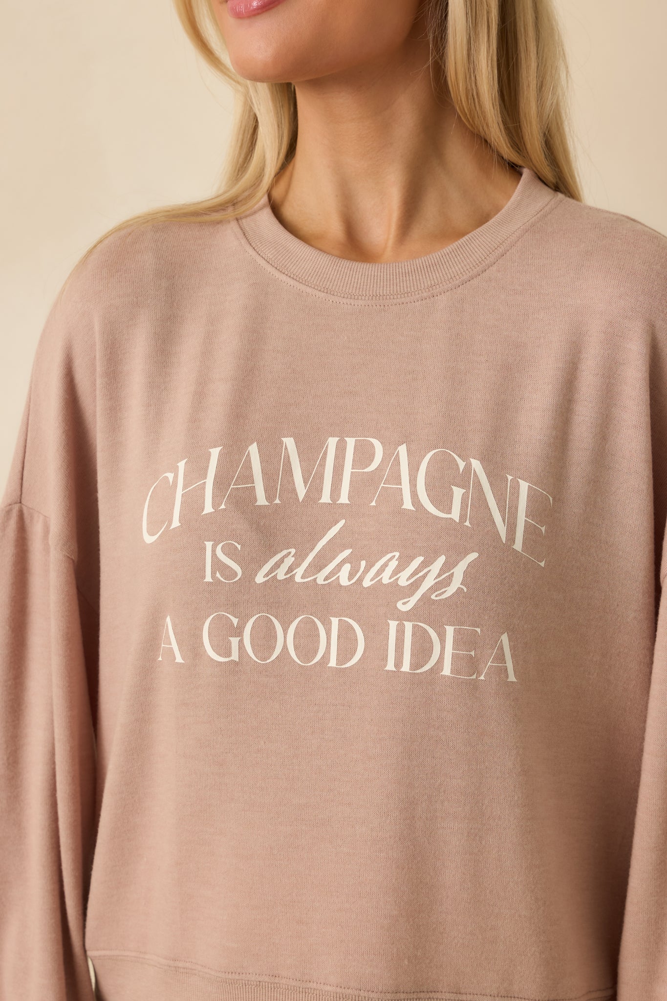 Detailed view of the printed text, knit fabric texture, and ribbed trim.