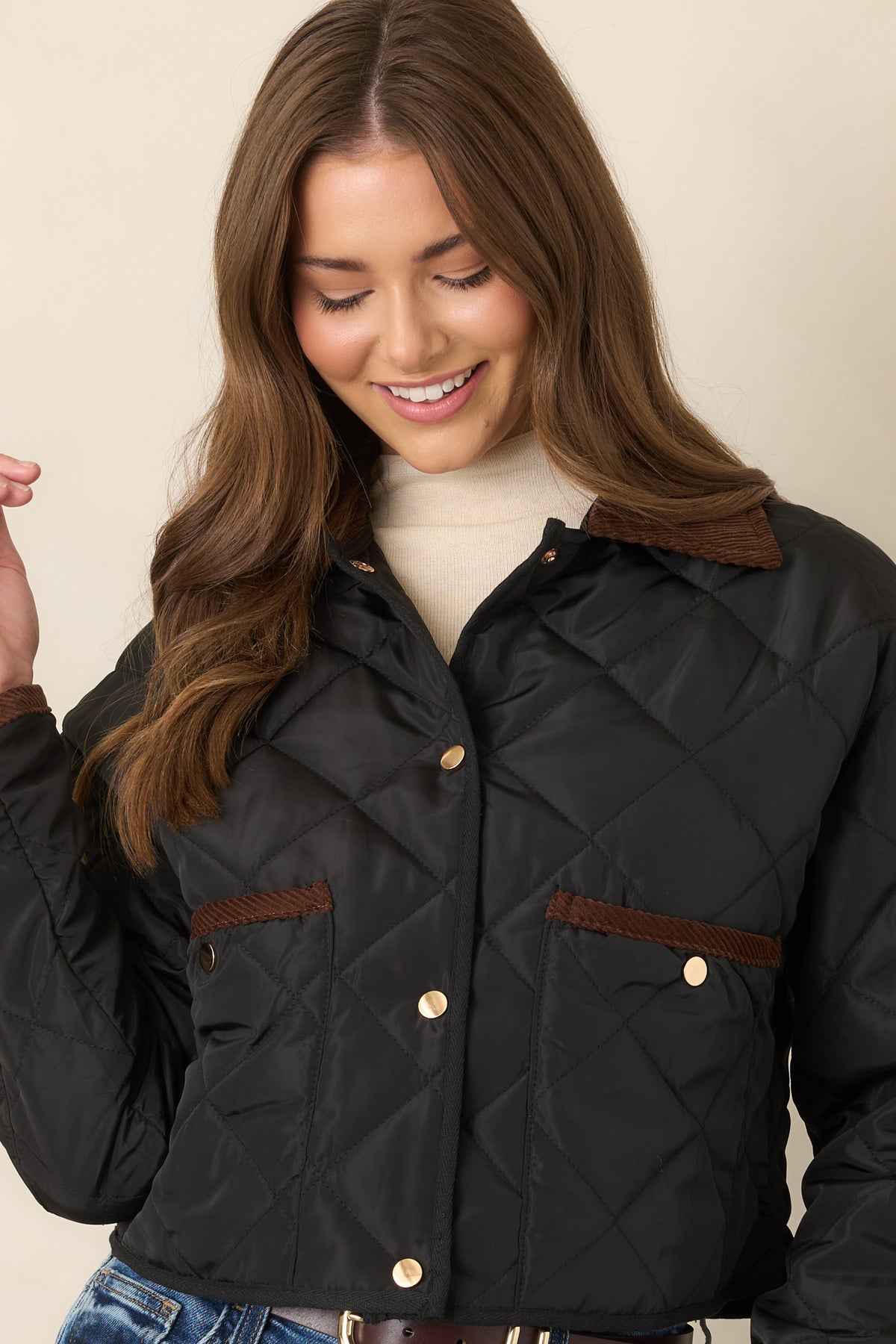 Diamond-stitched jacket featuring a rich brown collar, long sleeves, and a slightly cropped silhouette.