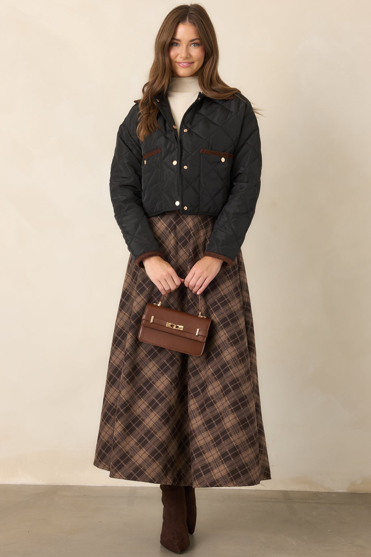 Diamond-stitched jacket featuring a contrasting brown collar, long sleeves, snap-front closure, and a slightly cropped silhouette.