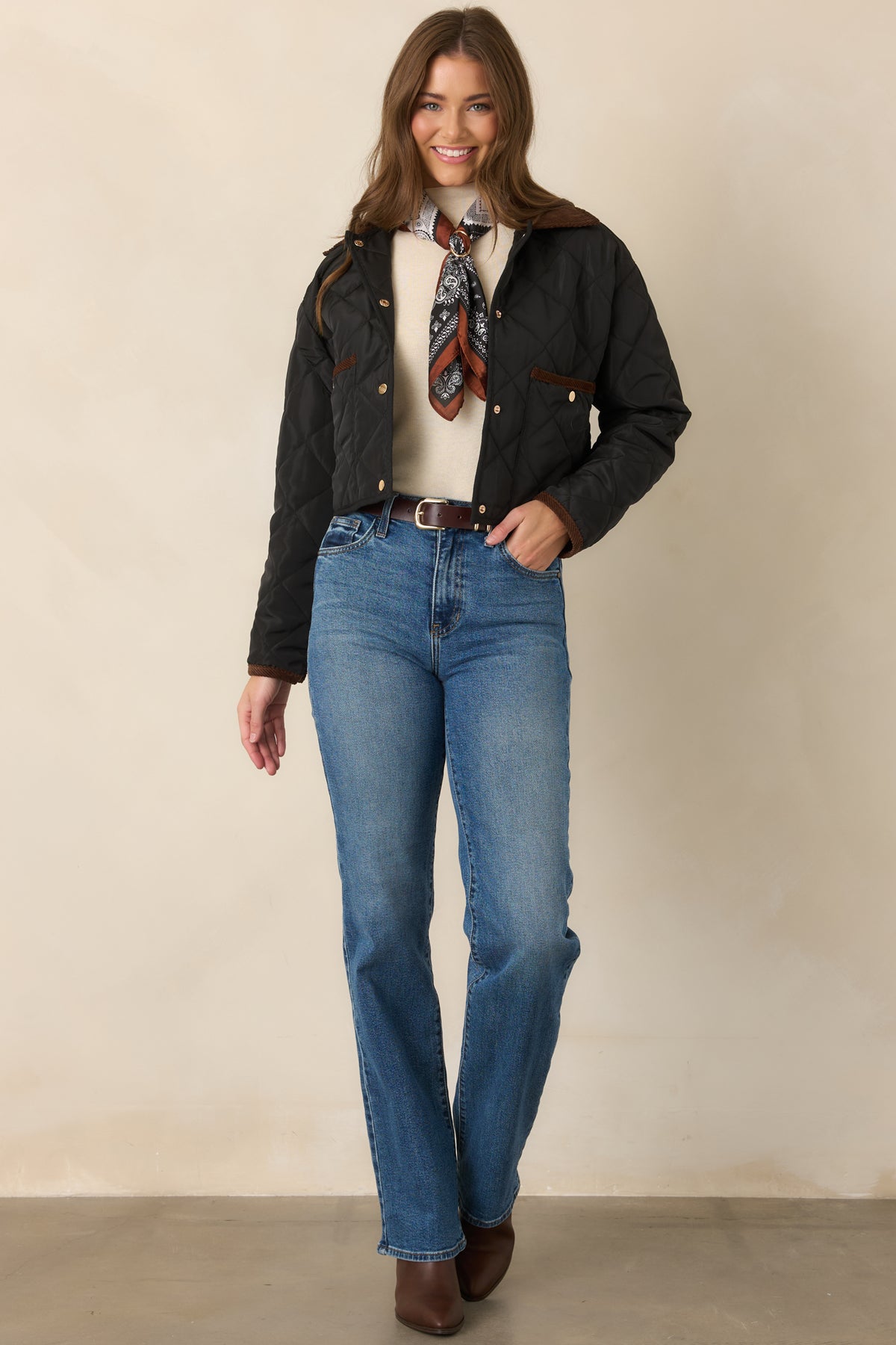 Classic diamond-stitched jacket designed with long sleeves, contrast-trimmed patch pockets, and coordinating black bottom binding.