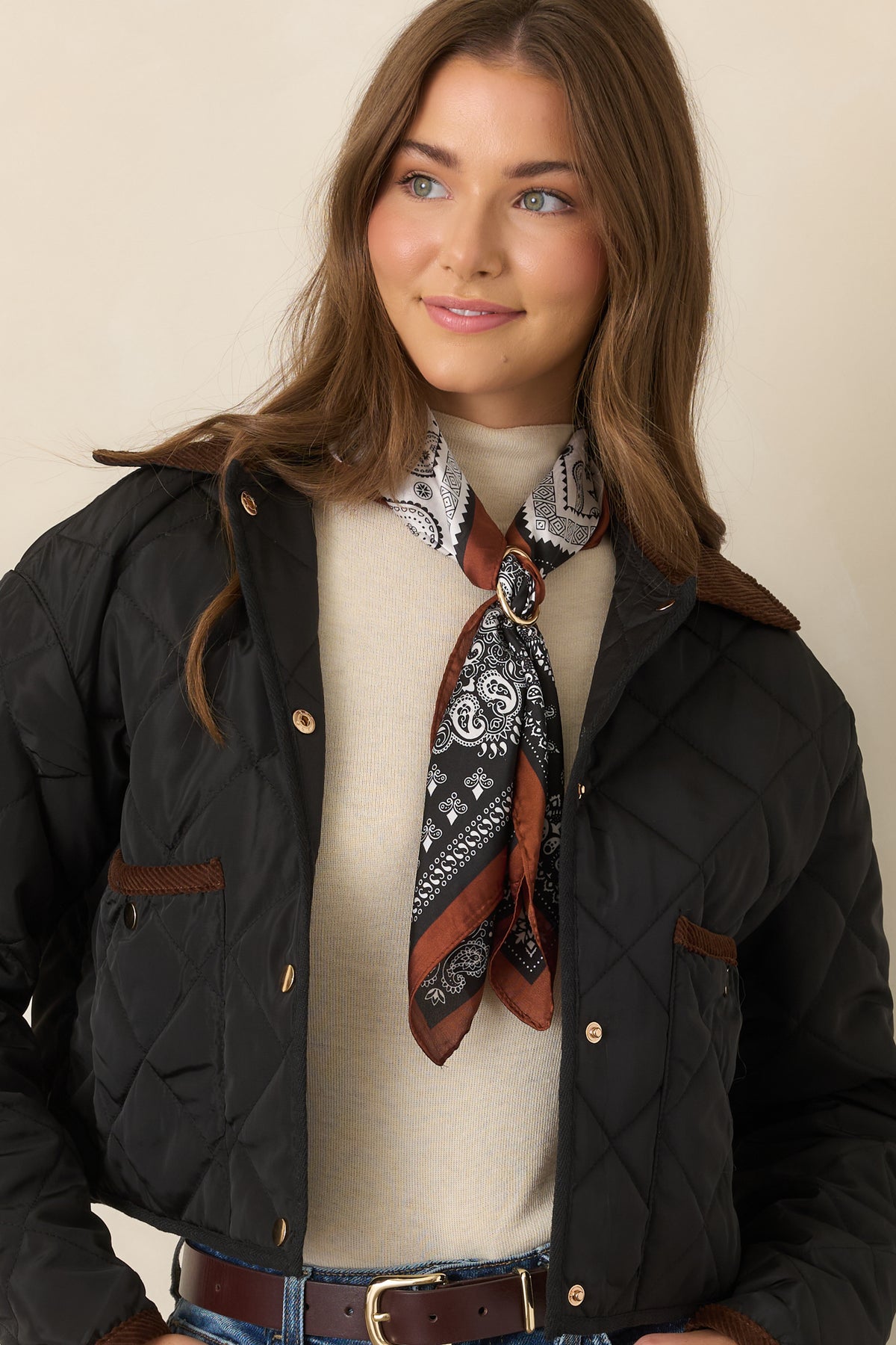 Jacket detail showcasing the snap-front closure and contrast-trimmed patch pockets against the diamond-stitched construction.