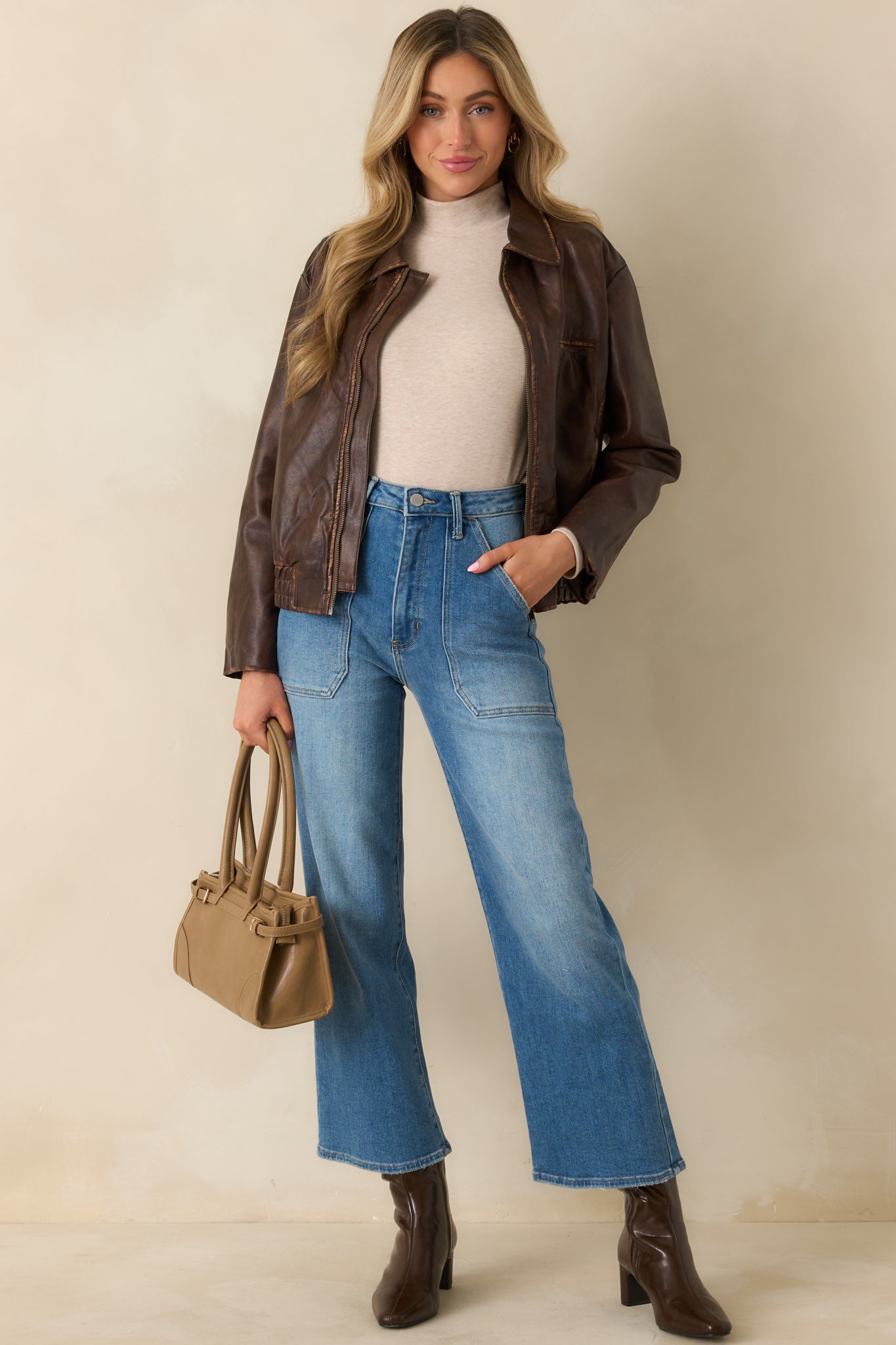 Distressed faux leather jacket highlighting the pointed collar and dropped shoulders.