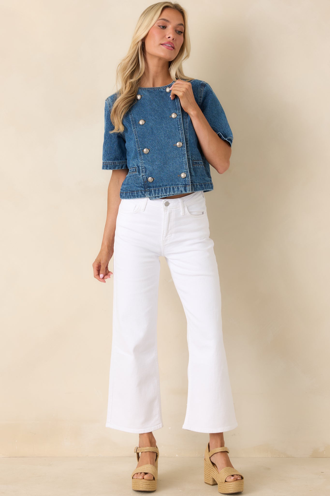 Double-breasted denim top with a round neckline and gold-tone buttons, designed in a slightly structured cropped silhouette