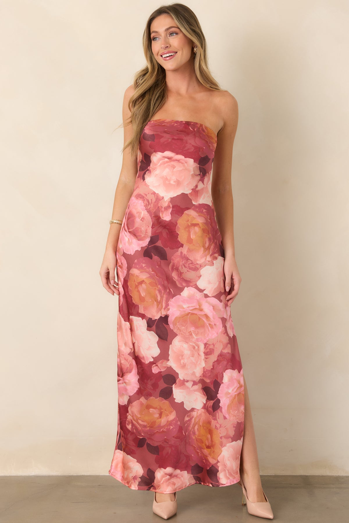 Dramatic strapless floral dress with oversized blooms, a fitted maxi silhouette, and thigh-high slit adding modern movement.