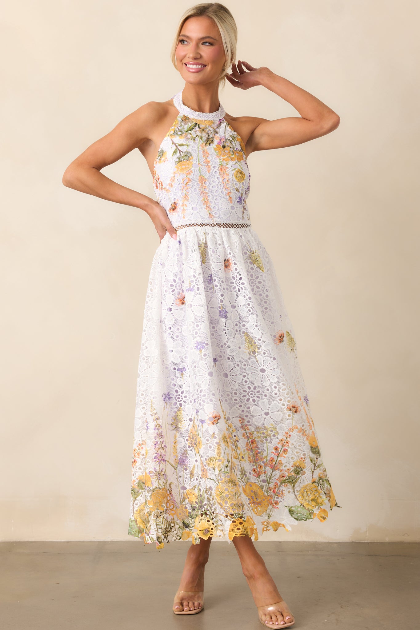 A dreamy midi dress with a white and yellow floral embroidered overlay, layered over a soft lavender lining.