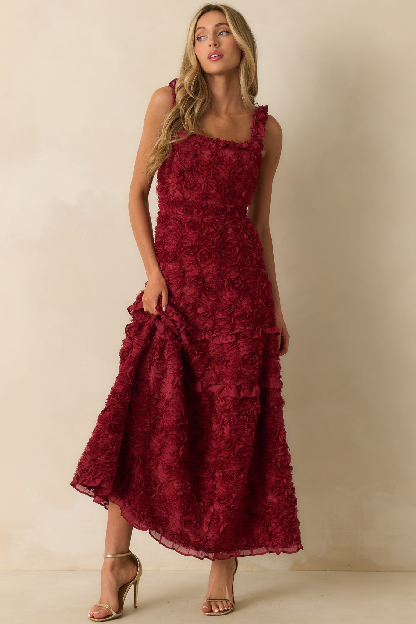 Dress adorned with 3D floral appliques and ruffle shoulder accents.