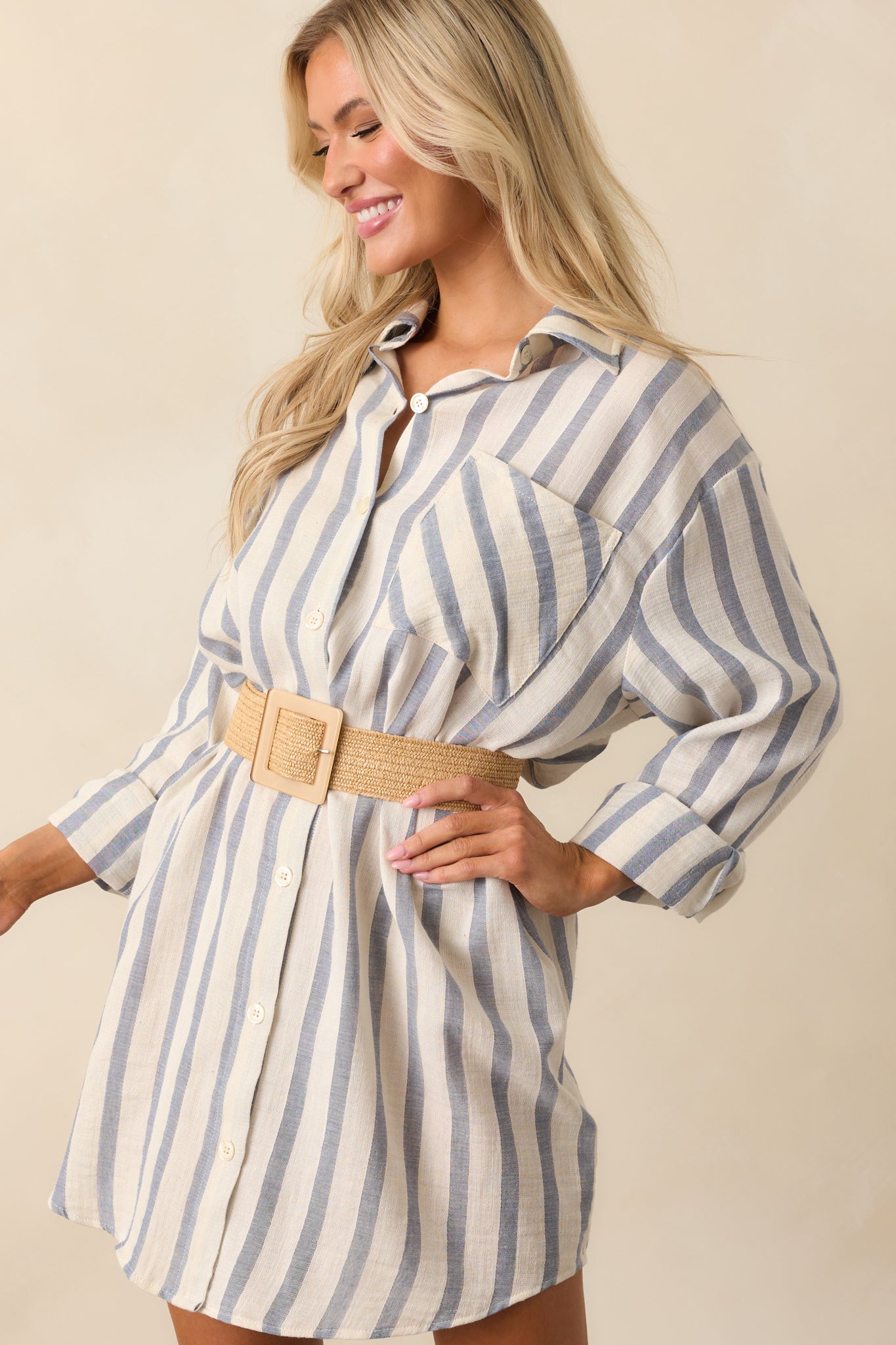 Lower portion of the dress cropped to highlight the curved scoop hem and stripe pattern.